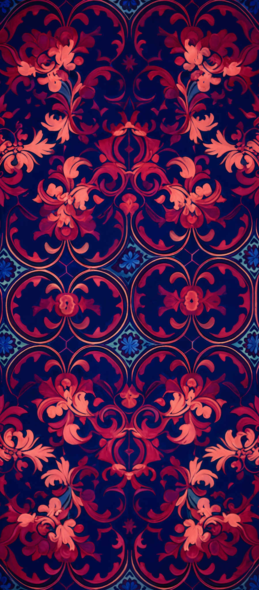 The image showcases a richly detailed and intricate pattern. The dominant colors are deep reds, vibrant oranges, and a hint of blue. The pattern consists of symmetrical designs, reminiscent of ornate floral motifs, intertwined with curvilinear and swirling shapes. The motifs are symmetrically arranged, creating a sense of balance and harmony.