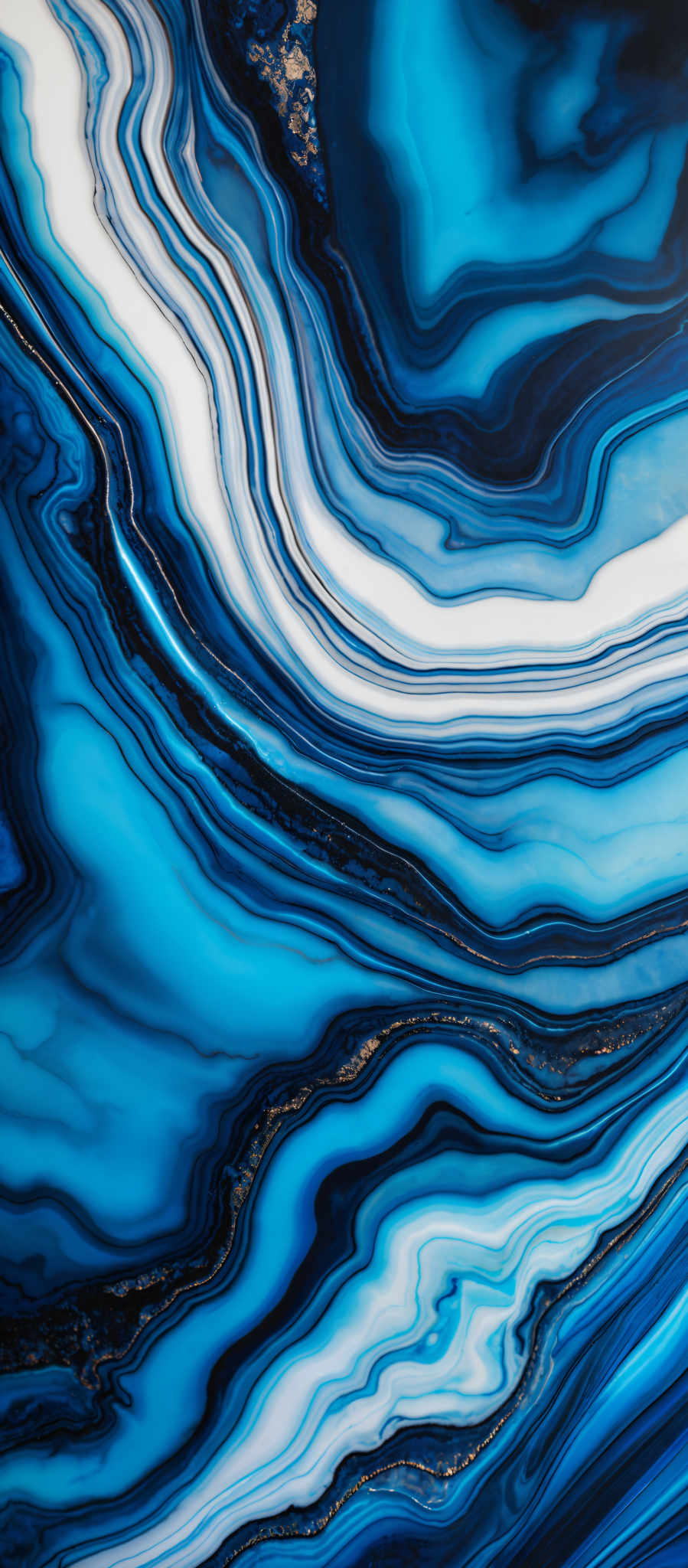 The image showcases a marbled pattern with a predominant color palette of blues and whites. The marbling appears to be fluid and organic, with swirls and layers creating a mesmerizing effect. The shapes are predominantly curvy and wavy, reminiscent of flowing water or waves. The intricate details and variations in the color gradient give the image a dynamic and textured appearance.