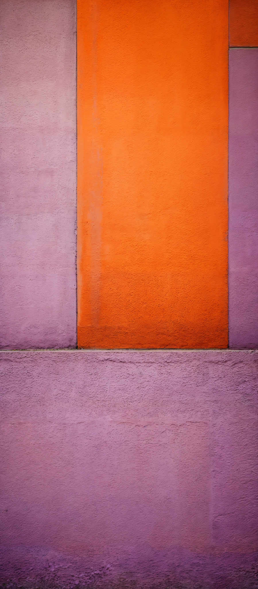 The image showcases a rectangular composition with three distinct sections. The top section is a deep shade of purple, the middle one is a vibrant orange, and the bottom one is also purple but lighter in tone. The orange section is divided by a thin vertical line, creating two rectangular segments. The bottom section has a textured appearance, possibly resembling a concrete or stone surface.