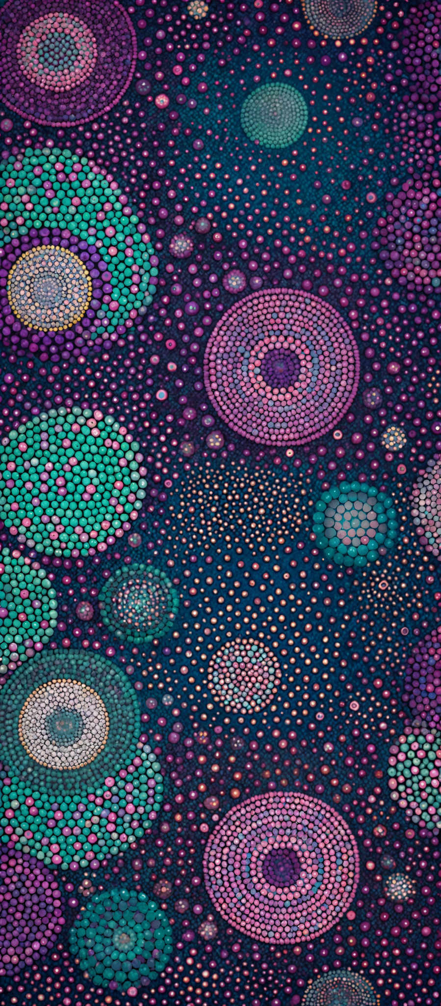 The image showcases a vibrant and intricate pattern of concentric circles. These circles are filled with a myriad of colors, including shades of purple, pink, green, and blue. The background is a deep blue, which contrasts beautifully with the colorful circles. The overall design gives an impression of a cosmic or celestial theme, with the circles resembling planets or celesteial bodies.