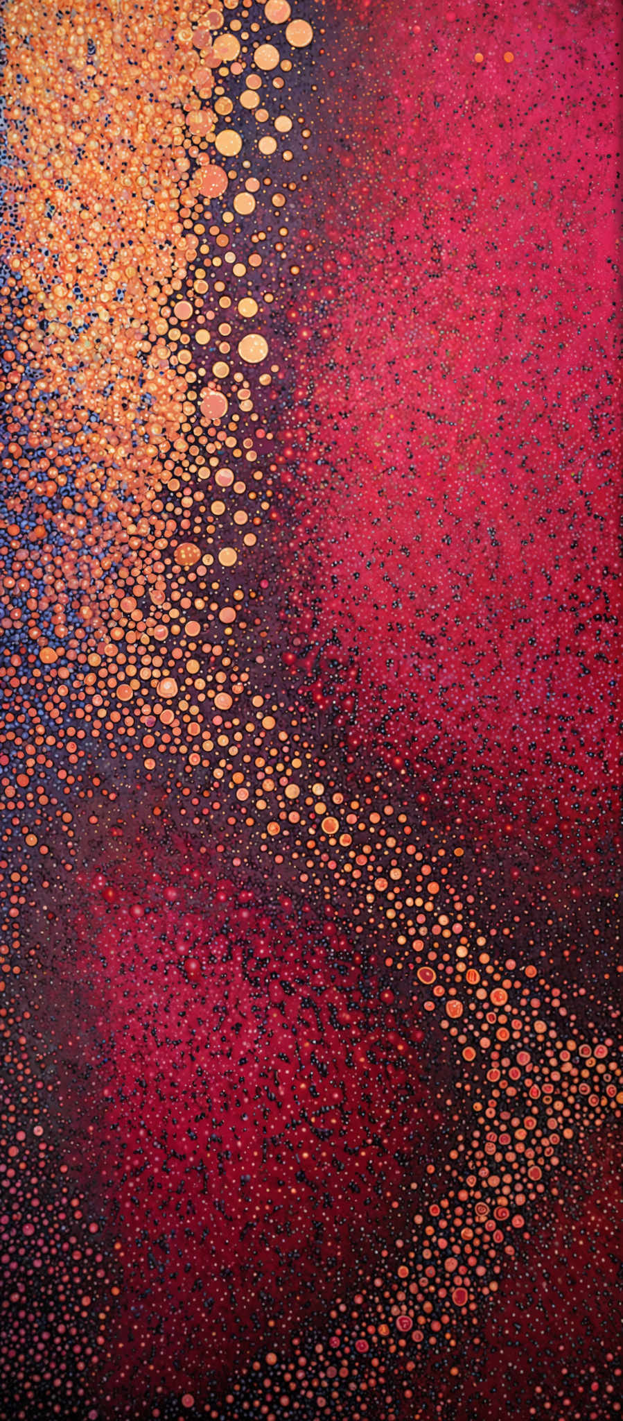 The image showcases a vibrant and colorful abstract pattern. The dominant colors are deep red, gold, and a hint of blue. The pattern consists of numerous small, circular shapes, resembling bubbles or droplets, dispersed throughout the canvas. The gold bubbly shapes are densely packed on the left side, gradually fading into the deep red as they move towards the right. The background is a rich, deep red that gradually transitions to a darker shade towards the bottom.