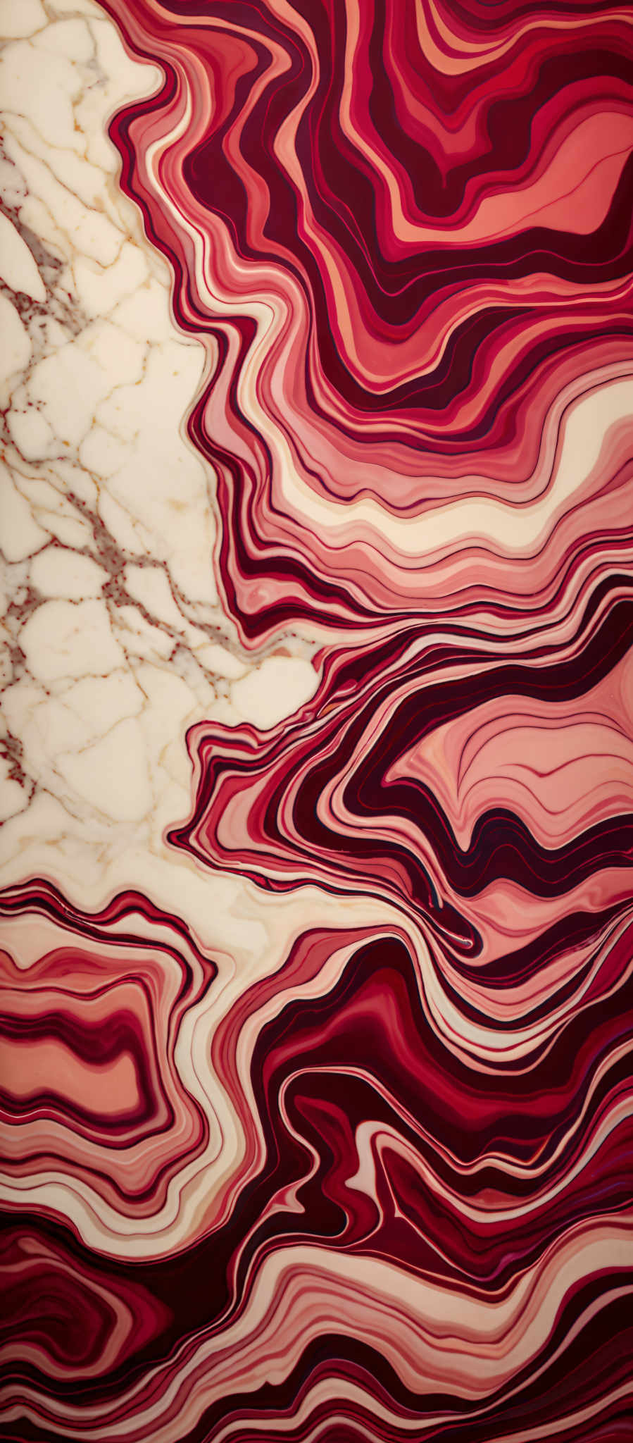 The image showcases a marbled pattern with a mix of red, pink, and white colors. The marbling pattern consists of wavy lines and swirls, creating an intricate and visually appealing design. The predominant colors are shades of red and pink with white marbling patterns interspersed.