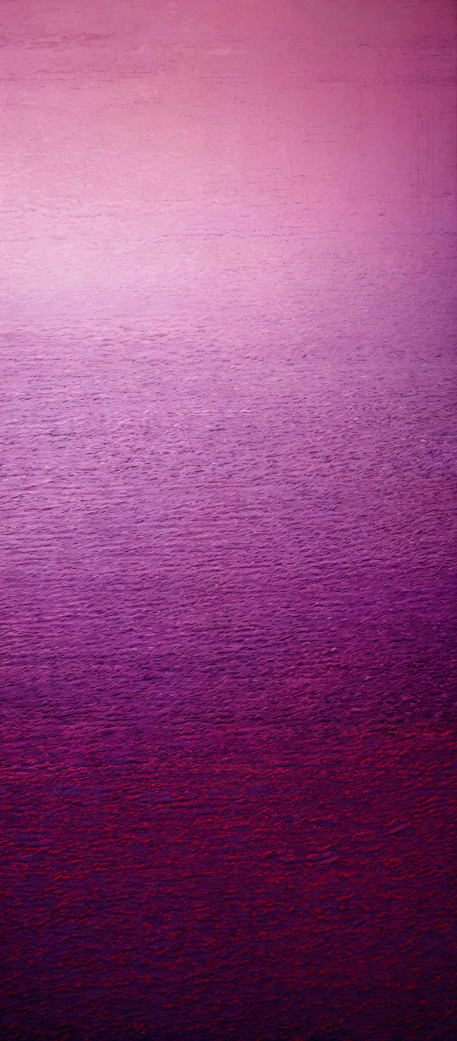 The image showcases a gradient of colors transitioning from a light pinkish hue at the top to a deep purple at the bottom. The top portion appears to be a calm sky, while the bottom section resembles a body of water, possibly a sea or ocean, reflecting the colors of the sky. The texture of the water is slightly rough, suggesting waves or ripples.