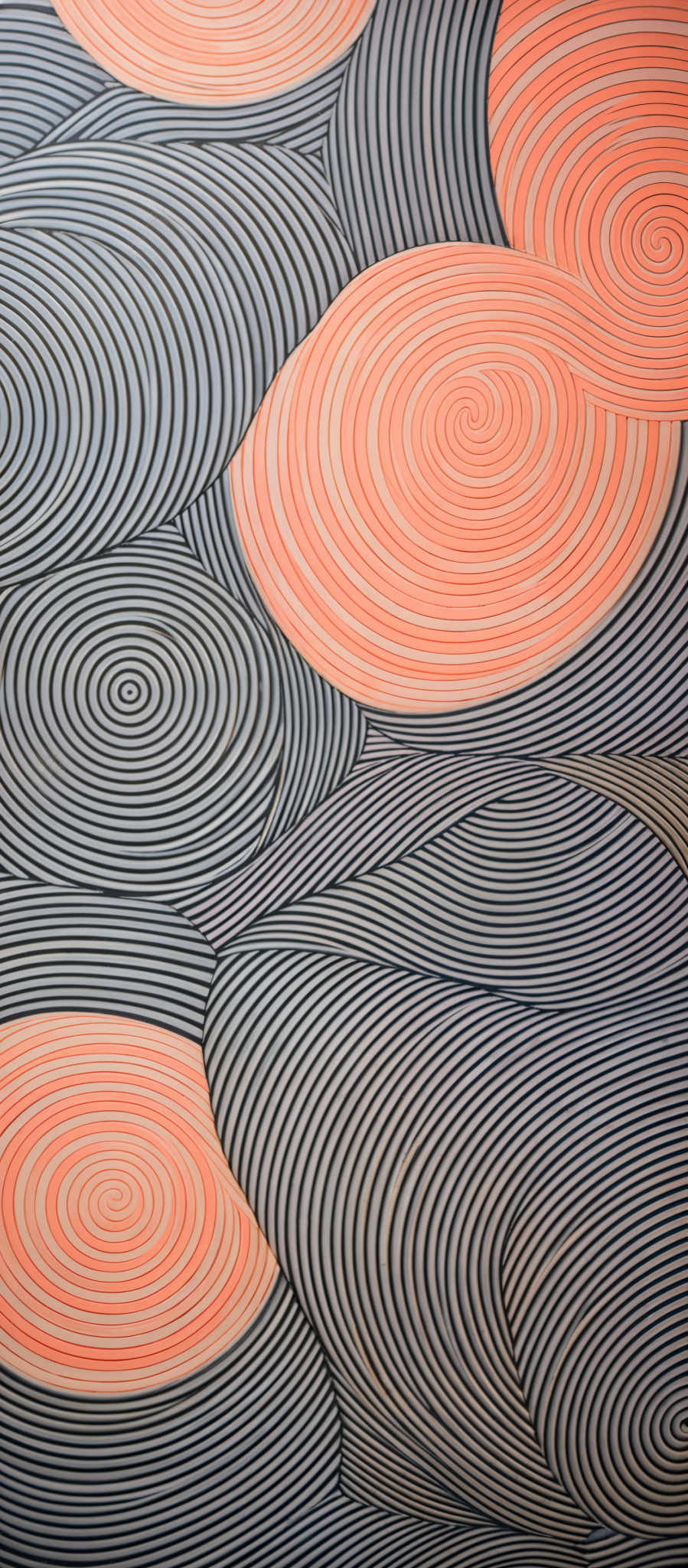 The image showcases a pattern with a combination of black and white lines forming intricate spirals and curves. There are also large, bold orange circles interspersed among the patterns. The design appears to be a blend of abstract art and geometric patterns, creating a visually appealing and mesmerizing effect.