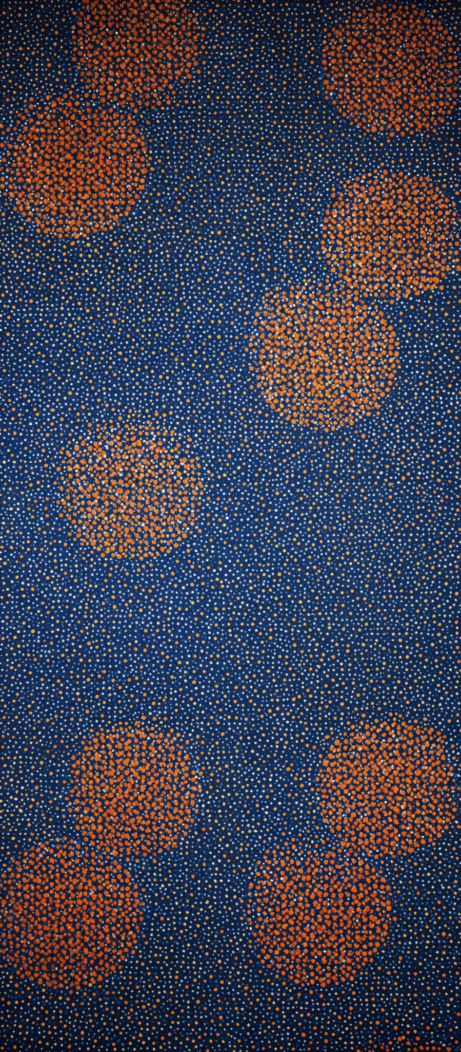 The image showcases a pattern with a predominant blue background. On this blue background, there are clusters of orange dots. These clusters are irregular in shape and seem to be spread out randomly.