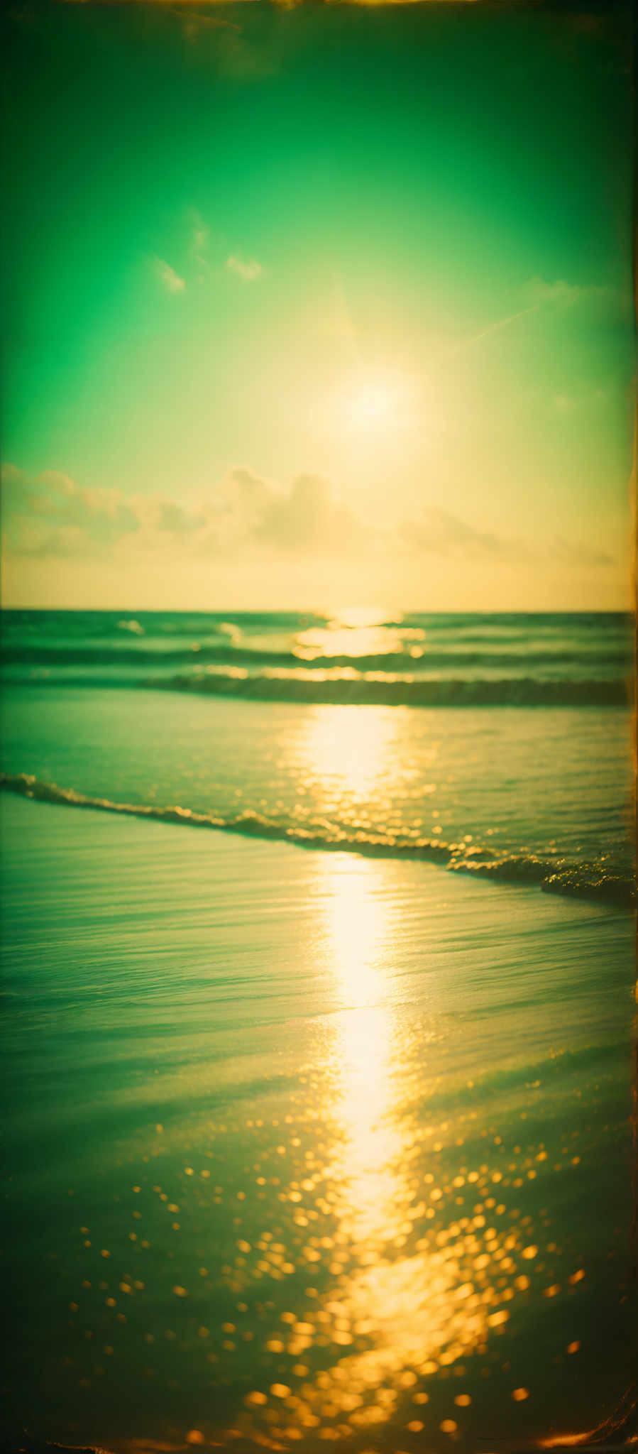 The image showcases a serene beach scene during sunset. The sky is painted in hues of blue and turquoise, with the sun casting a golden glow. The sun's reflection shimmers on the water's surface, creating a mesmerizing pattern. The waves gently crash onto the shore, and their foamy white crests contrast with the darker sand. The overall ambiance of the image is tranquil and evokes a sense of peace.