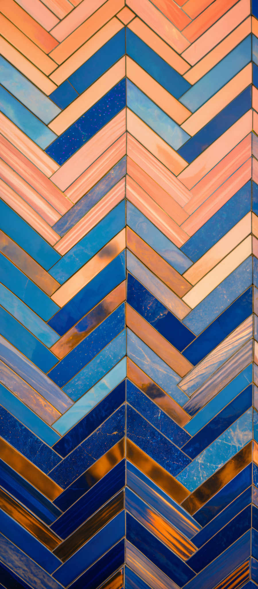 The image showcases a series of interconnected rectangular tiles arranged in a zigzag pattern. These tiles exhibit a variety of colors, including shades of blue, peach, and gold. Some tiles have a glossy finish, while others have a textured appearance. The combination of these colors and textures creates a visually appealing and intricate pattern.