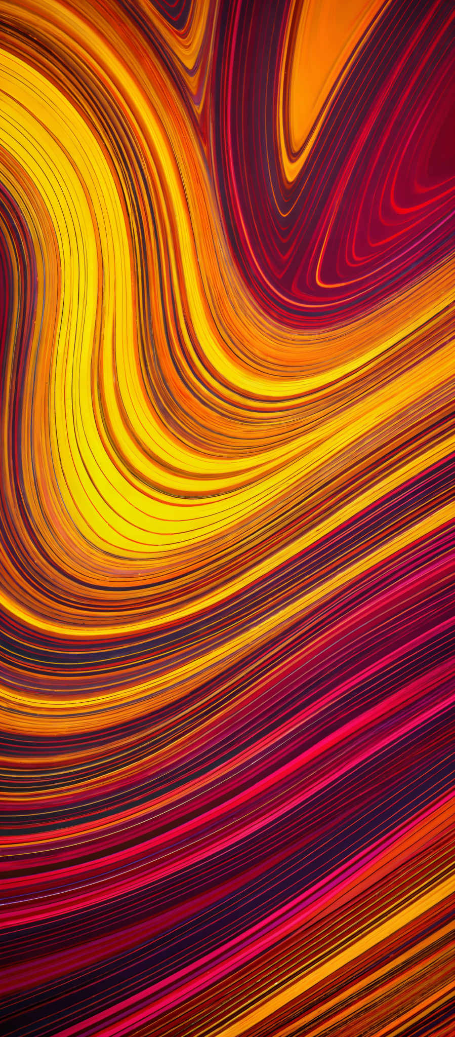 The image showcases a vibrant and dynamic abstract pattern. It predominantly features a mix of red, yellow, and orange hues, creating a swirling and wavy effect. The swirls are fluid and appear to be in motion, giving the image a sense of depth and movement. The shapes are predominant curvy lines, with some areas having a more concentrated flow of color, while others have a more spread out distribution.