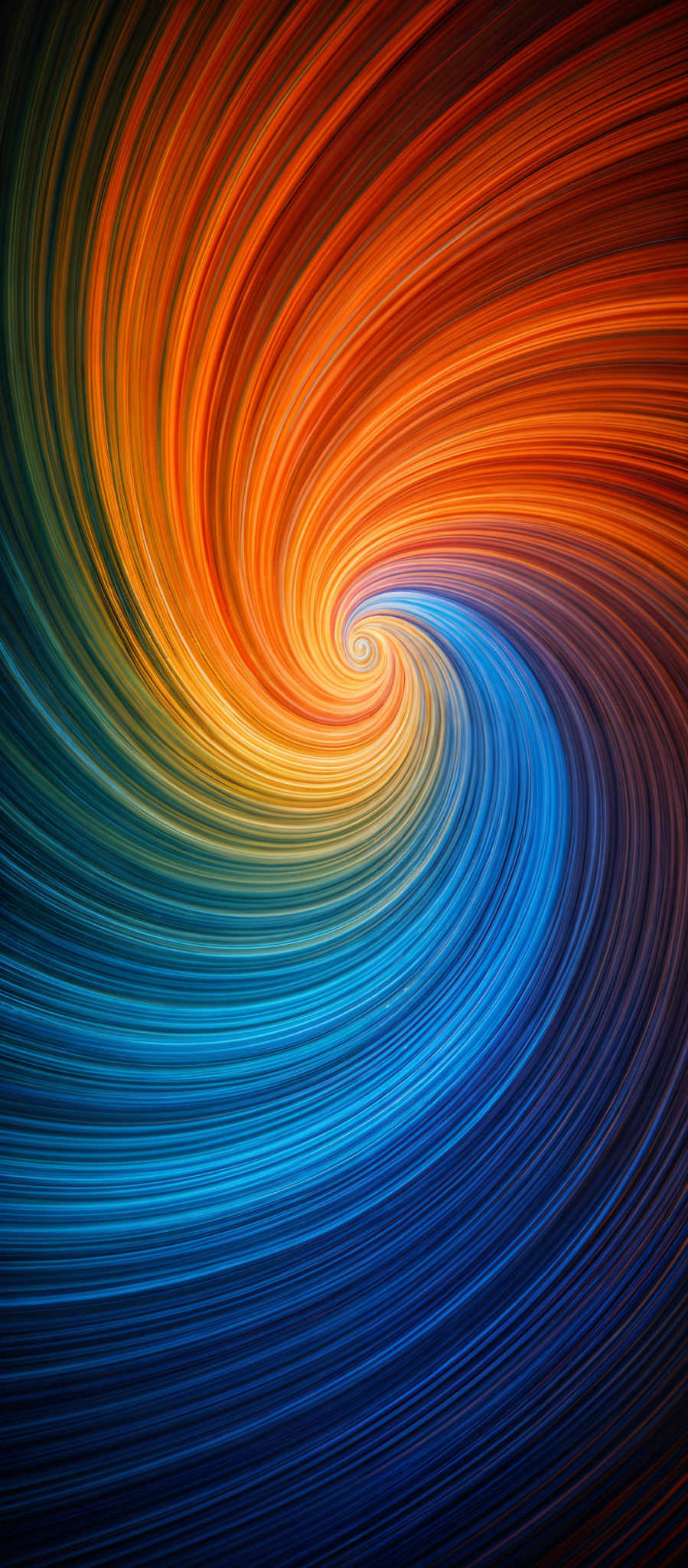 The image showcases a vibrant swirl of colors, predominantly featuring hues of orange, yellow, blue, and green. The swirl takes on a spiral shape, with each color transitioning smoothly into the next, creating a harmonious blend. The gradient of colors transitions from a deep blue at the bottom to a fiery orange at the top, giving the impression of a dynamic, flowing movement.