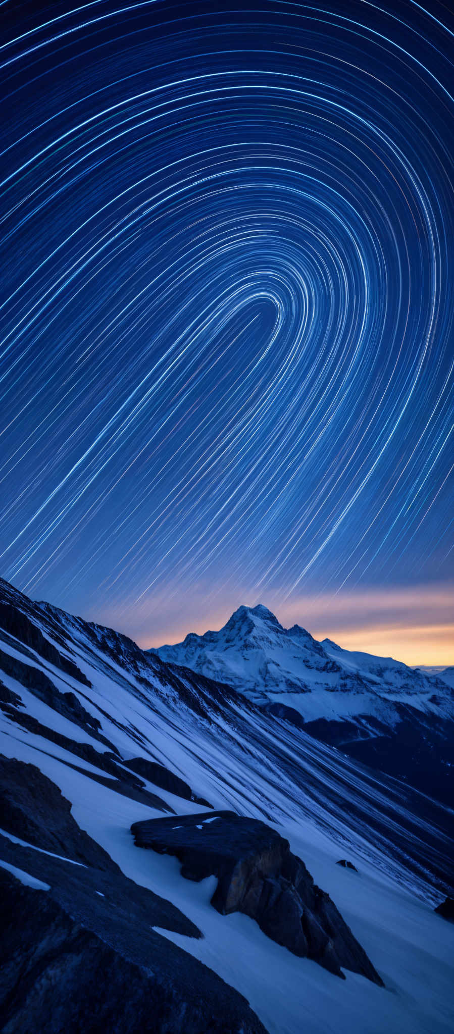 A mountain range with a sunset in the background.