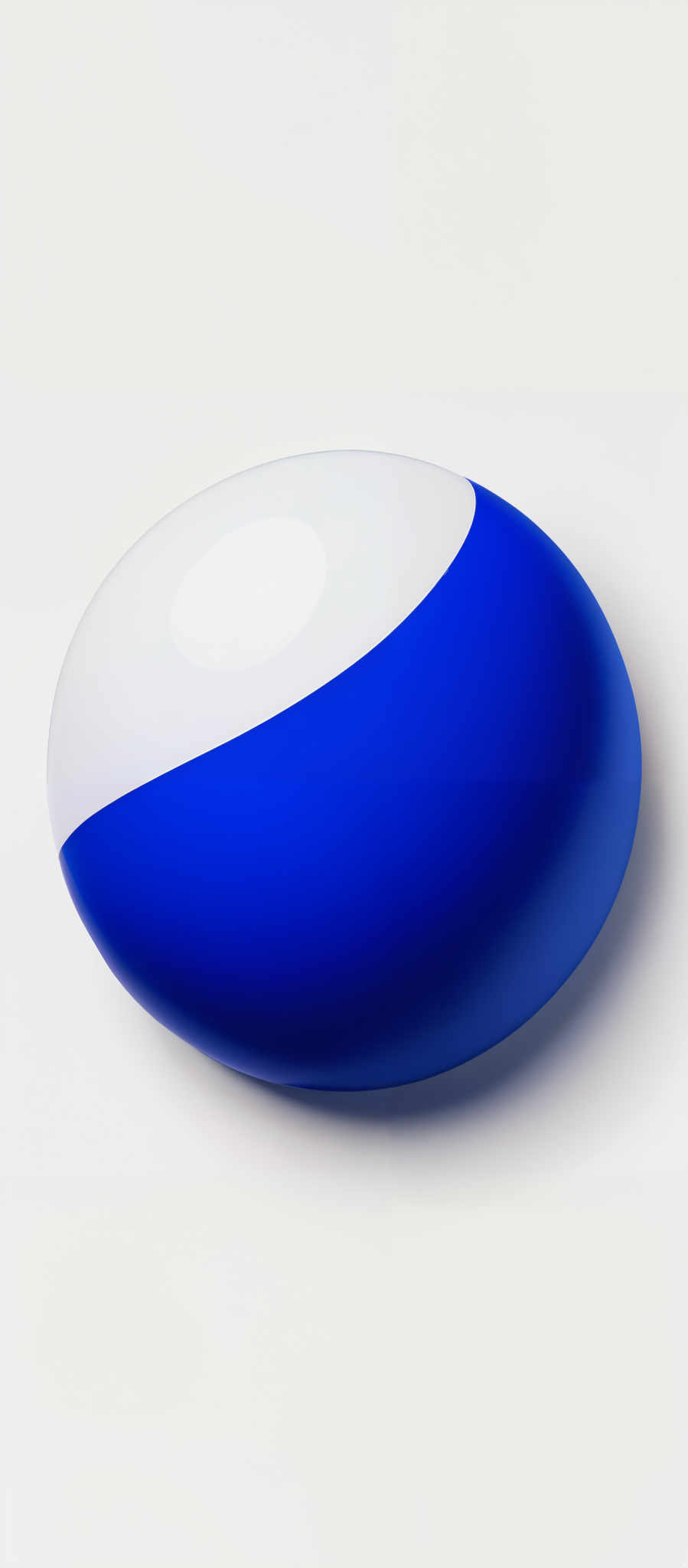 The image showcases a two-toned elliptical object. The upper half is a vibrant shade of blue, while the lower half is white. The object appears to be glossy, reflecting light, and is set against a plain white background.