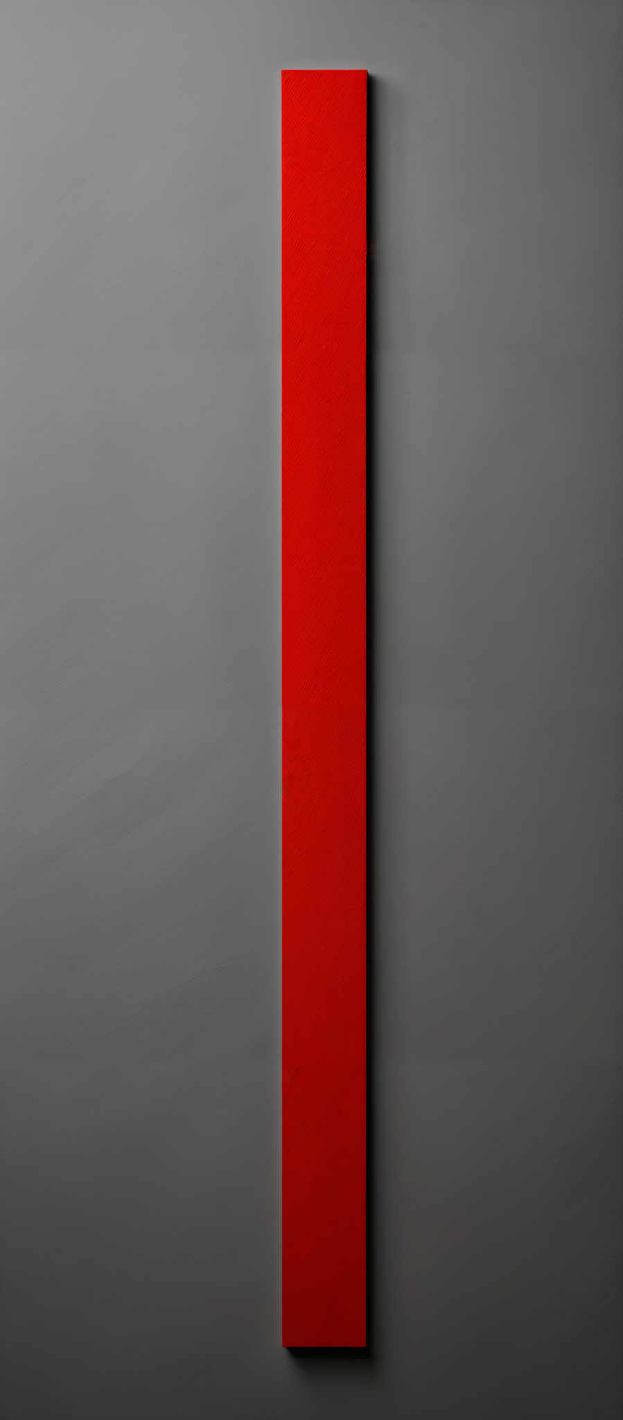 The image showcases a vertical rectangular shape with a vibrant red hue. The background is a muted gray, providing a stark contrast to the red. The texture of the red appears to be slightly grainy, suggesting it might be a physical object or a representation of a material.