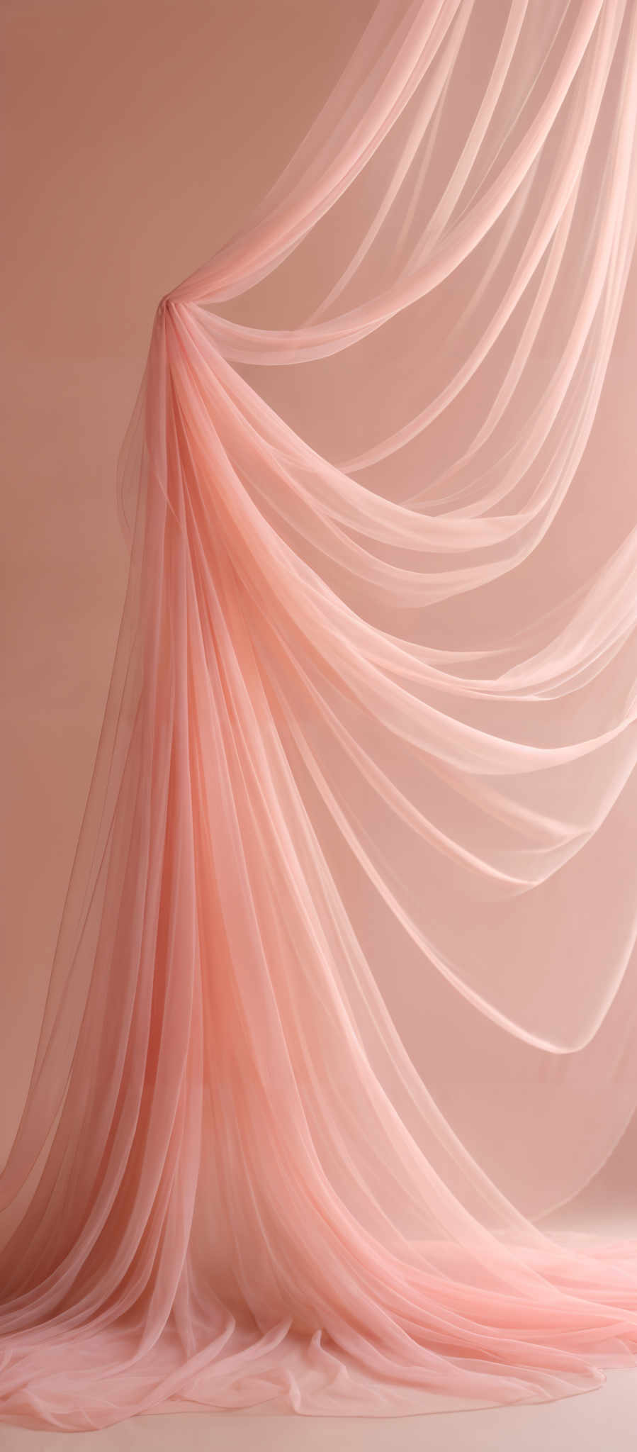 The image showcases a series of flowing, translucent fabric in varying shades of pink. The fabric drapes elegantly, creating a cascading effect, with some portions gathered and others spread out. The background is a muted pink, complementing the fabric's hue. The overall ambiance is soft, ethereal, and dreamy.