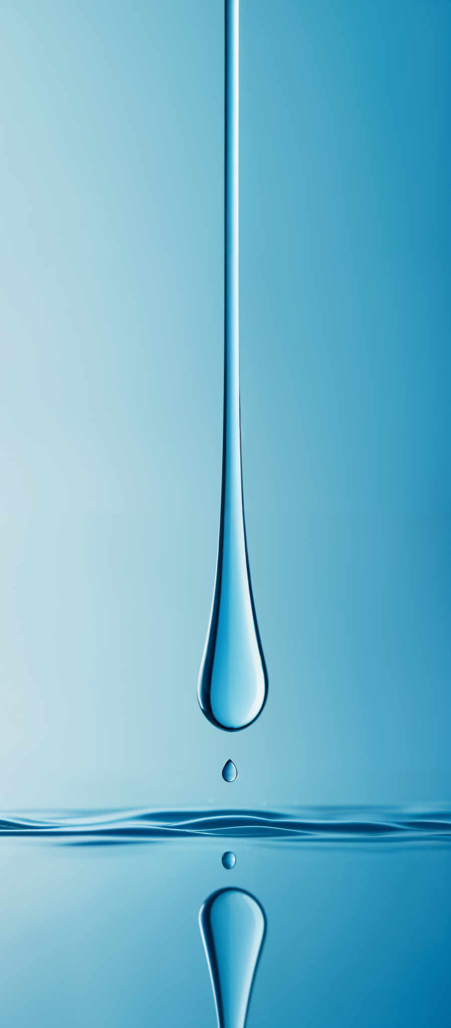 The image showcases a striking blue hue, dominated by a large, elongated droplet suspended in mid-air. Below the main droplett, there's a smaller droplets, which seems to have just fallen, creating a ripple effect on the surface below. The background is a gradient of light blue, which accentuates the luminosity of the dropletes. The overall shape and composition give a sense of fluidity and elegance.