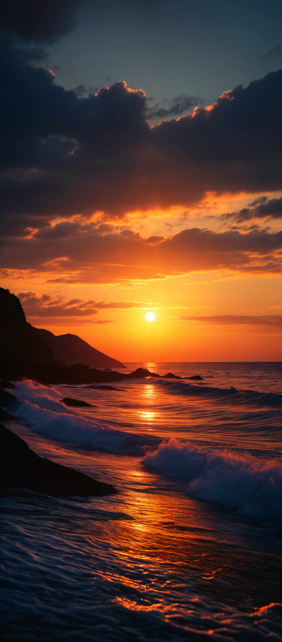 The image showcases a breathtaking sunset over a beach. The sun is positioned near the horizon, casting a warm golden hue across the sky. The sky is adorned with dark, dramatic clouds that are illuminated by the setting sun. The waves gently crash onto the shore, reflecting the sun's golden light. The silhouette of a cliff or mountain can be seen on the left side of the image, adding depth to the scene.