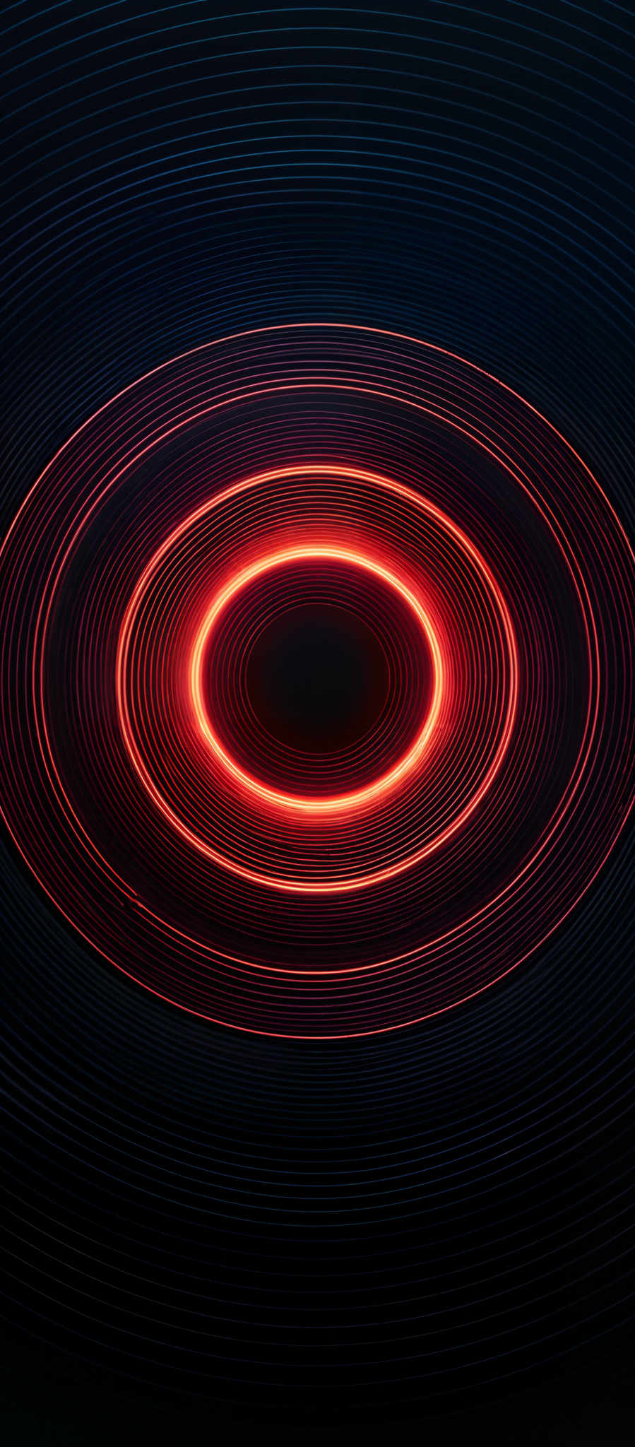 The image showcases a vibrant and mesmerizing pattern of concentric circles. The circles are radiating outward from a central point, with each layer exhibiting a gradient of colors ranging from deep blue at the outermost rings to a fiery red-orange hue at the innermost circle. The intricate design creates an illusion of depth and movement, giving the impression of a spinning or swirling vortex.