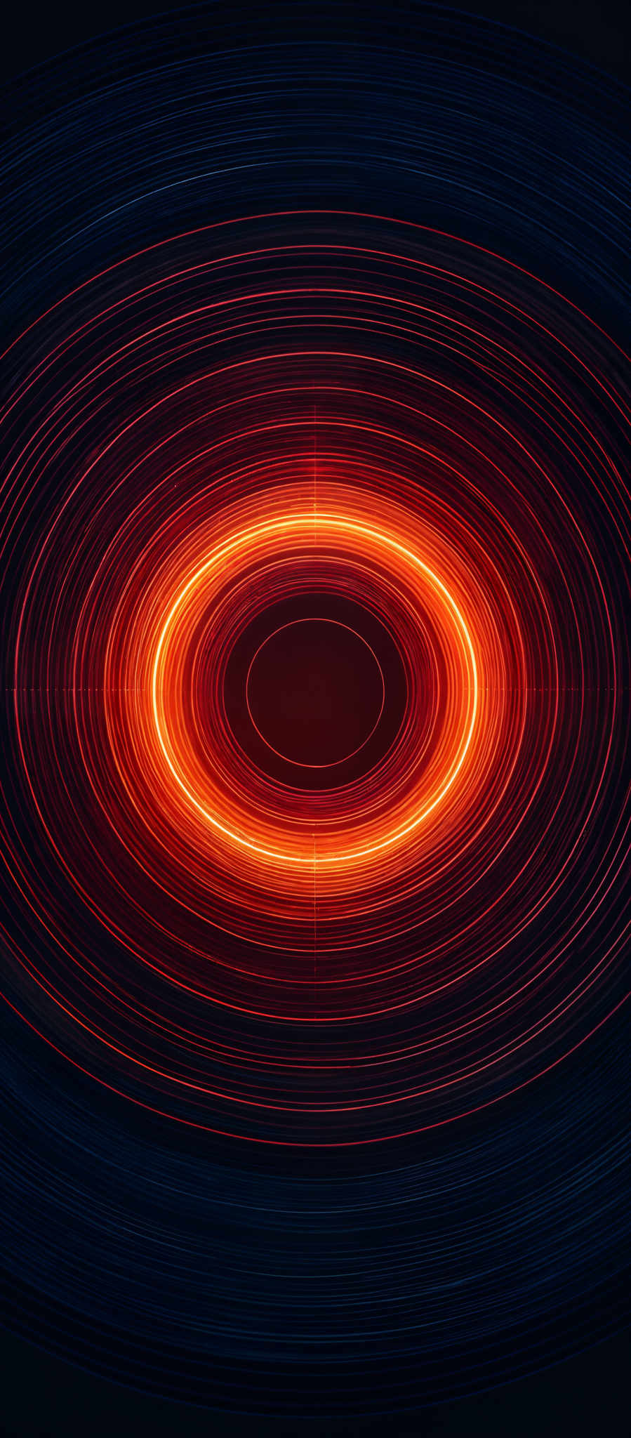 The image showcases a vibrant and mesmerizing pattern of concentric circles. The colors range from deep blues at the outermost layers to fiery reds and oranges at the innermost circle. The circles appear to be made of swirling lines, giving the impression of dynamic energy or movement. The central circle is the brightest, with a deep red hue, and it seems to be the focal point of the image, drawing the viewer's attention.