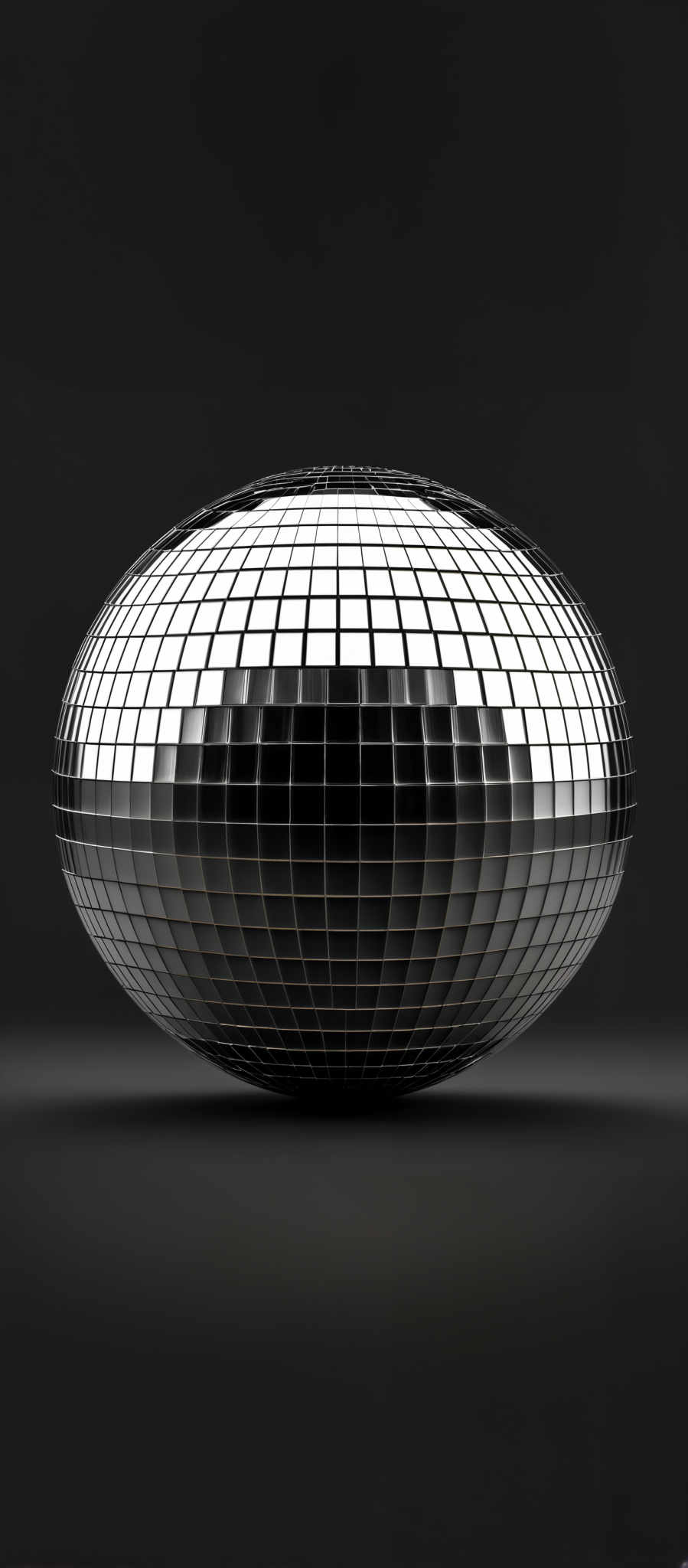 The image showcases a spherical object with a reflective, mirrored surface. The sphere is divided into a grid of smaller squares, creating a pattern that reflects light in a manner reminiscent of a disco ball. The background is dark, emphasizing the reflective properties of the sphere. The overall color palette is monochromatic, with shades of black, white, and gray.