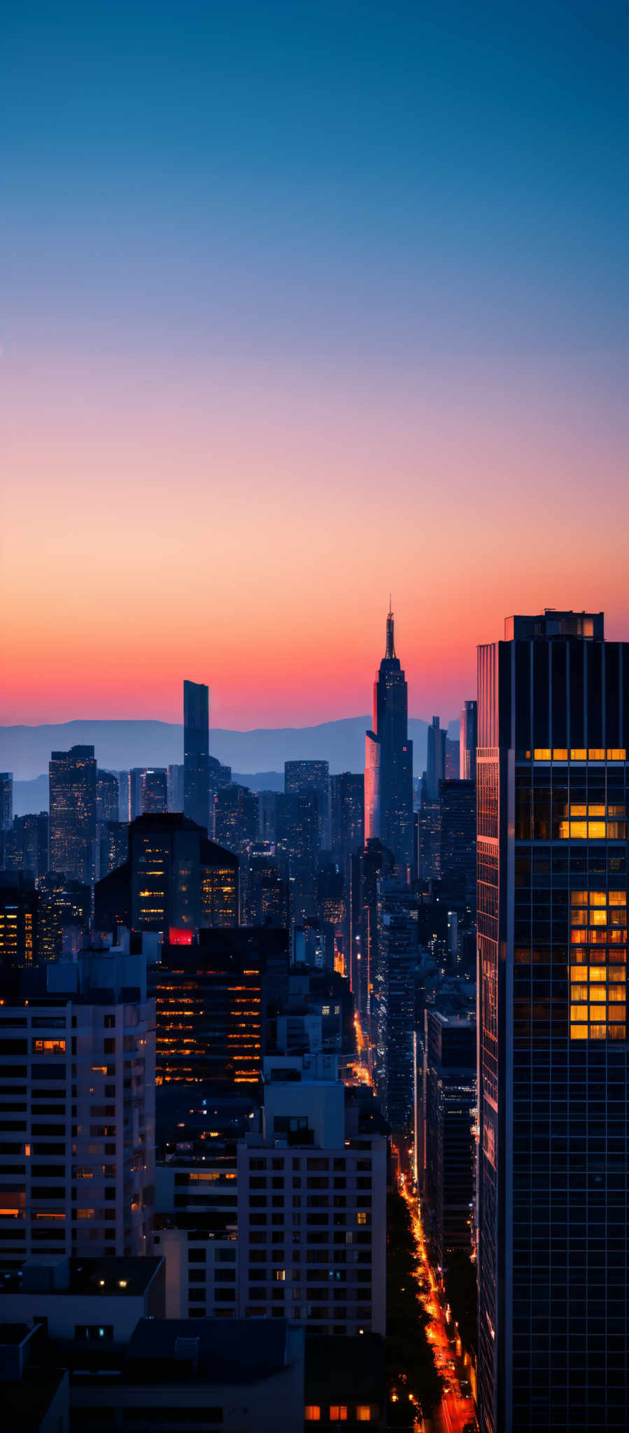 The image showcases a cityscape during sunset or sunrise. The sky is painted with hues of blue, pink, and orange, transitioning smoothly from one color to another. The city below is bustling with tall buildings, some of which are illuminated, reflecting the colors of the sky. The buildings vary in shape and design, with some having modern glass facades and others having more traditional architectural styles. The streets below are also lit, suggesting the onset of nighttime.