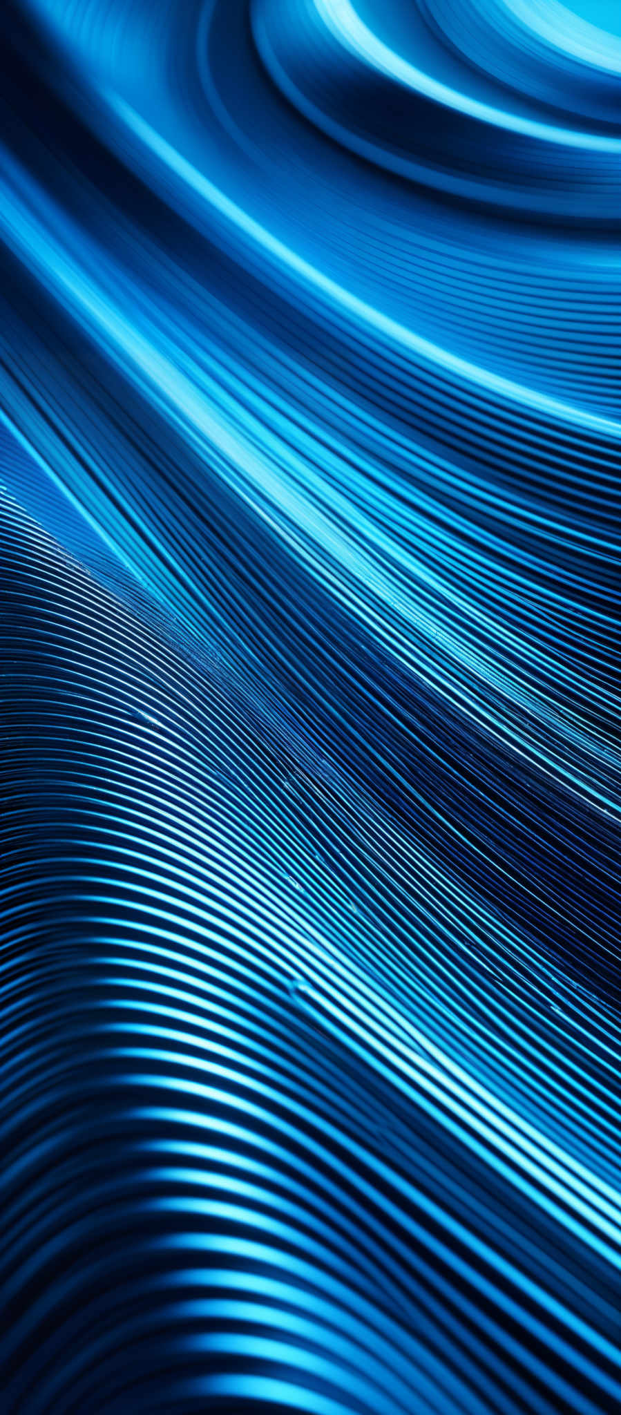 The image showcases a series of intertwined, parallel lines that create a flowing, wavy pattern. The colors are predominantly shades of blue, ranging from deep navy to lighter azure. The lines are closely packed together, creating a sense of depth and movement. The overall shape is reminiscent of flowing water or waves, giving the image a dynamic and fluid appearance.