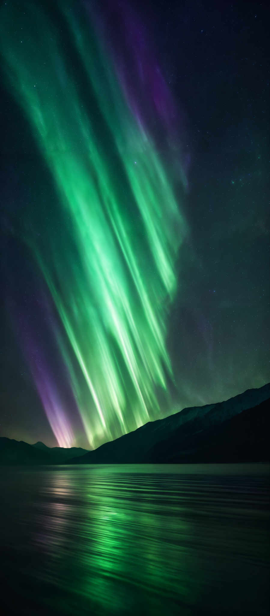 The image showcases a breathtaking view of the Northern Lights, also known as the Aurora Borealis. The lights display a vibrant array of colors, predominantly green and purple, cascading down in vertical streaks against a dark night sky. These streaks seem to originate from a point above the horizon and gracefully descend towards the water below. The water reflects the colors of the lights, creating a mirrored effect. In the background, there are faint stars scattered across the sky, adding to the ethereal beauty of the scene.