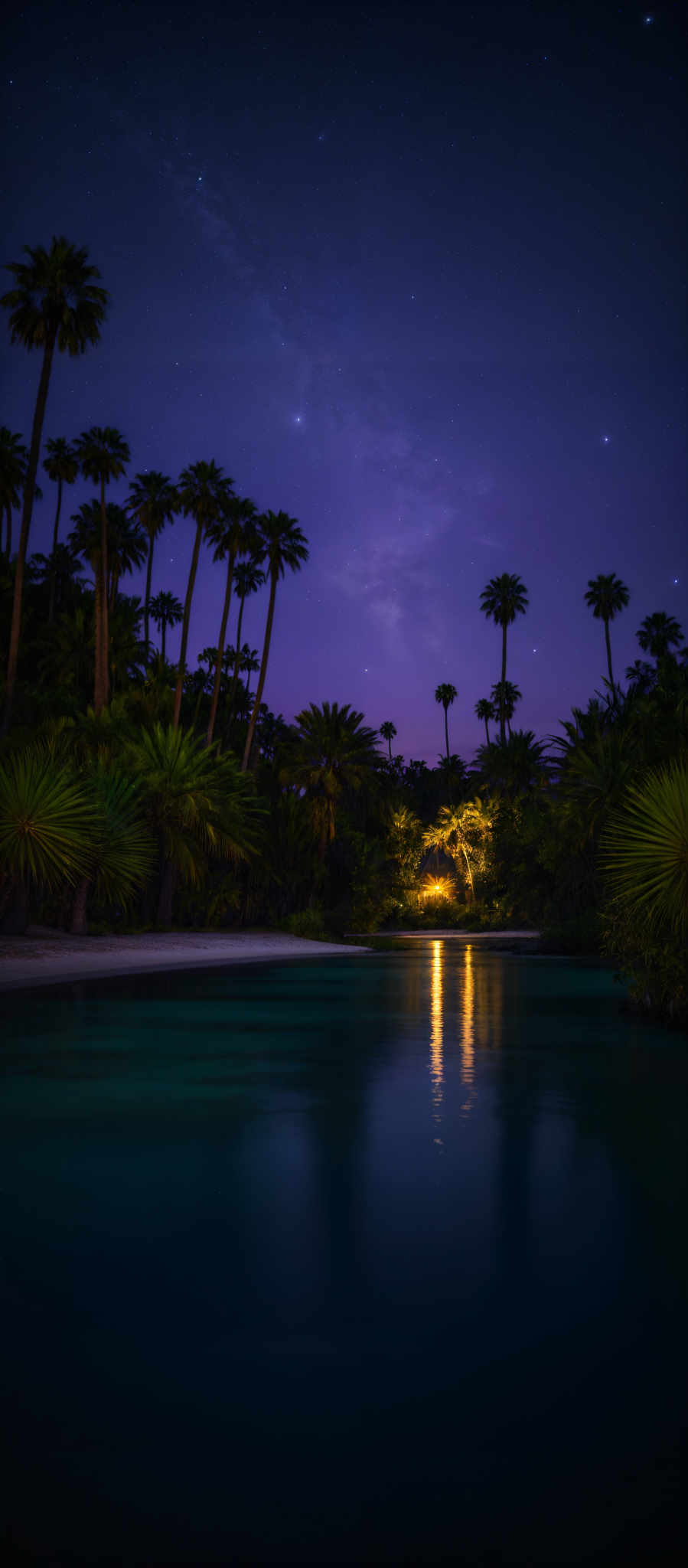 The image showcases a serene nighttime landscape. The sky is painted with hues of deep blue and purple, dotted with stars. The Milky Way can be seen stretching across the sky, with its dense cluster of stars creating a radiant, cloud-like appearance. Below, a calm body of water reflects the colors of the sky and the silhouettes of tall palm trees that line its banks. The water's surface is smooth, with a gentle ripple near the center, where a small light source emits a warm, golden glow. The trees, with their elongated trunks and fan-like leaves, stand tall and majestic, adding depth and contrast to the scene.