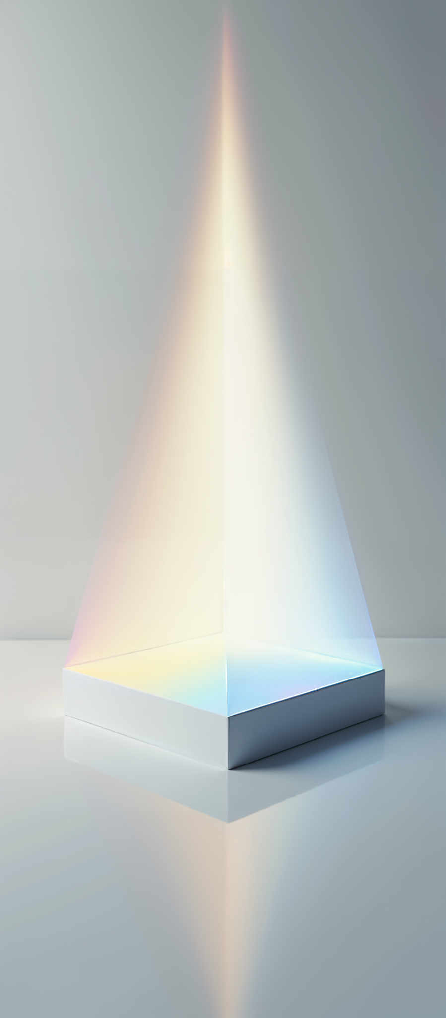 A white cube with a rainbow of light on it.