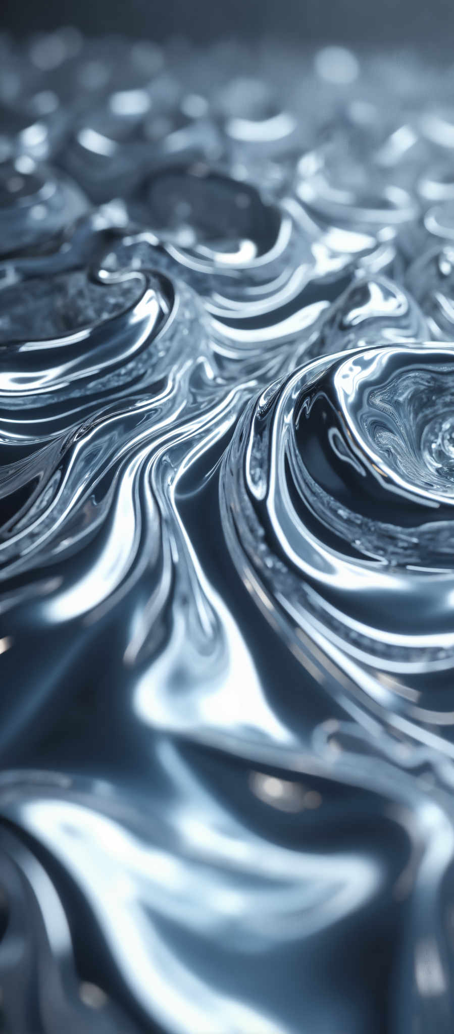 A close up of a shiny metallic surface with a spiral pattern.