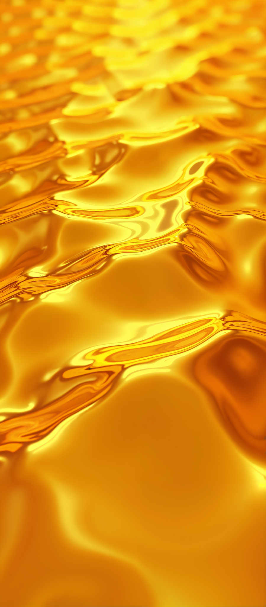 A close up of a shiny golden surface with a wavy pattern.