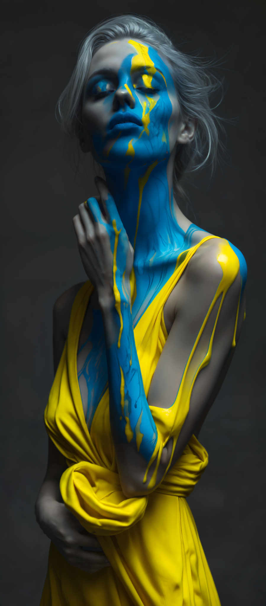 A woman's arm is painted with blue and yellow paint.