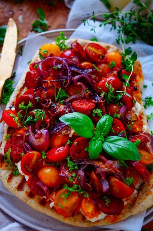 Flatbread pizza with chorizo, tomatoes and ricotta