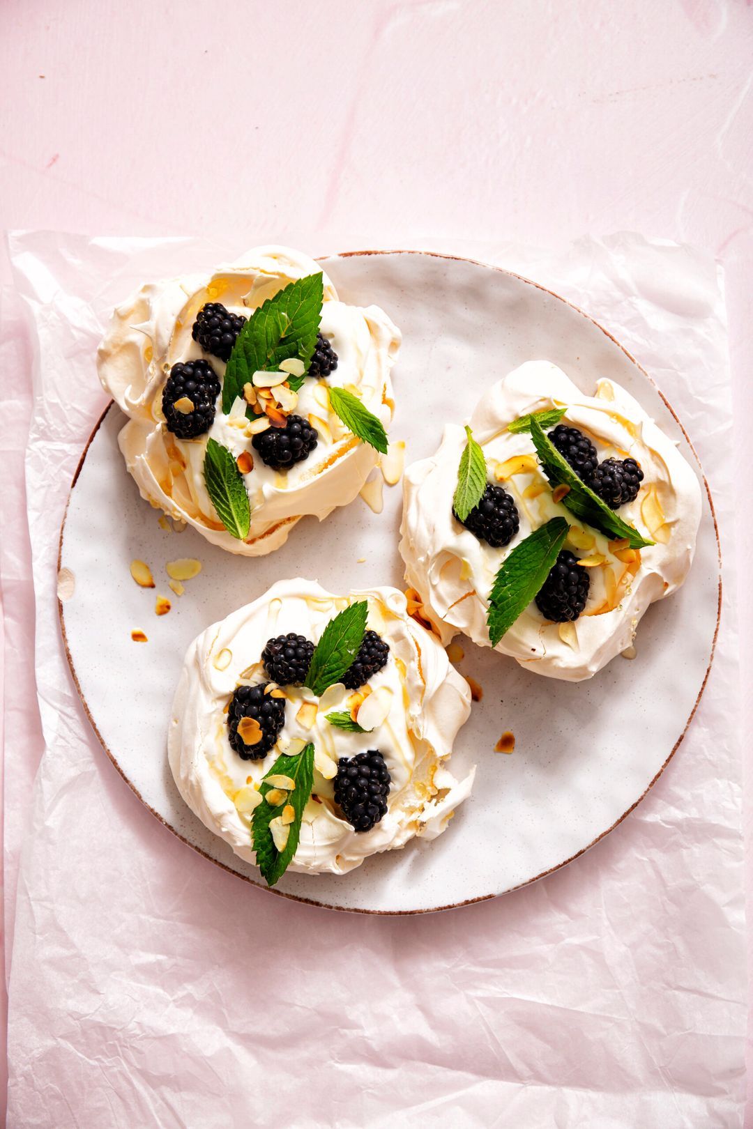 Mini pavlovas with blackberries, honey and mint