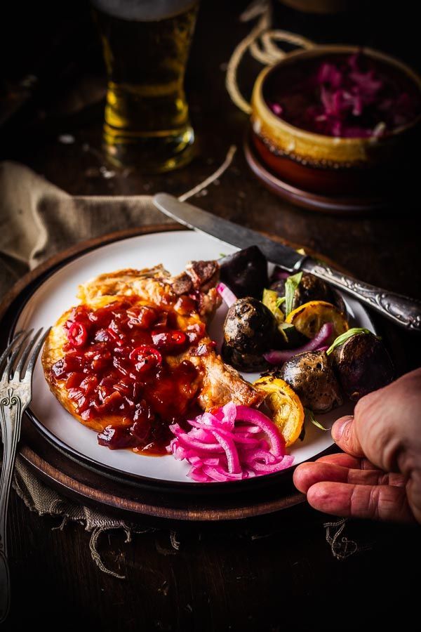 Juicy pork cutlet with red onion sauce on the bbq