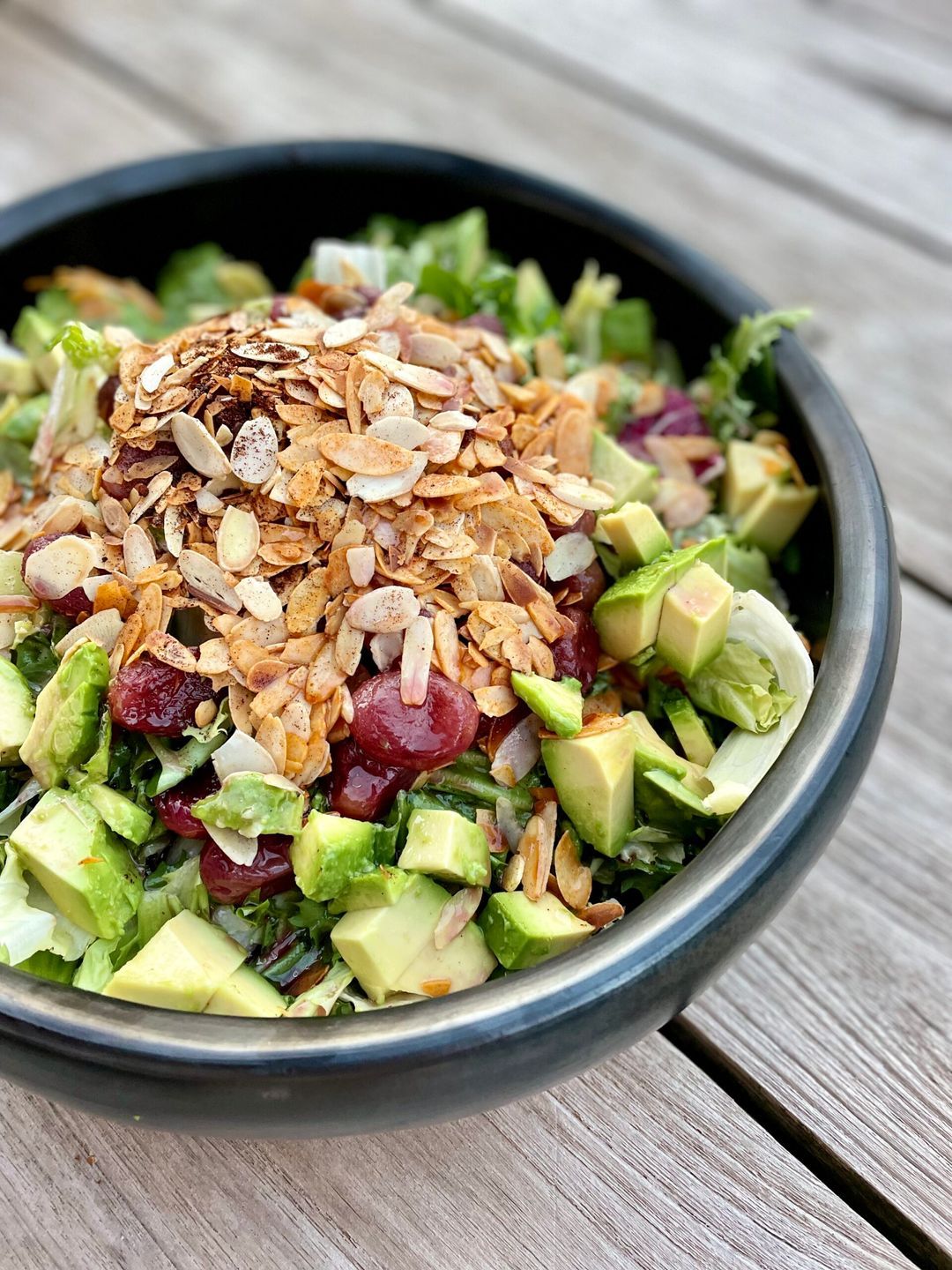 Salad with roasted grapes, avocado and almonds
