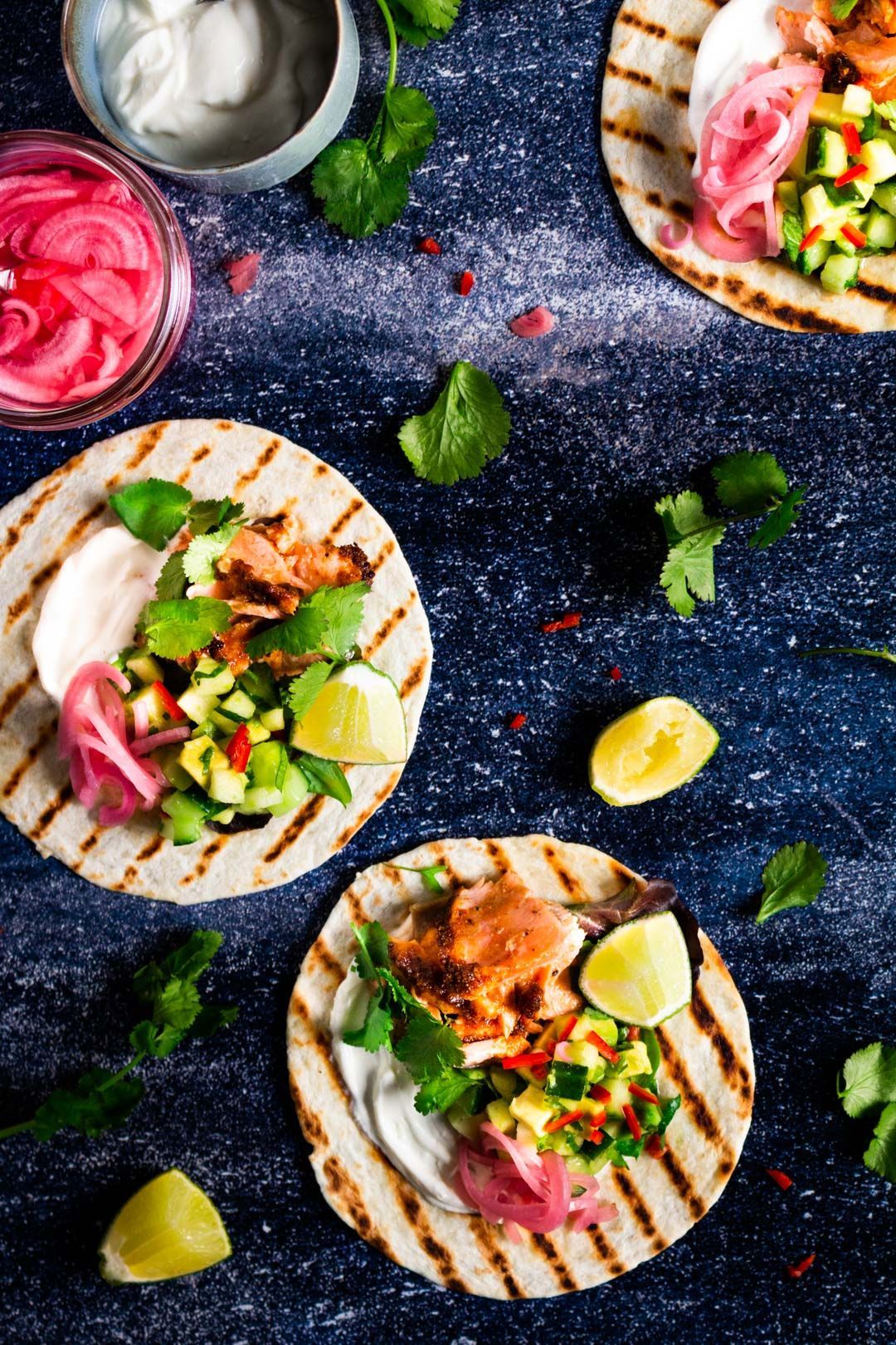 Salmon taco with avocado salsa and sour cream