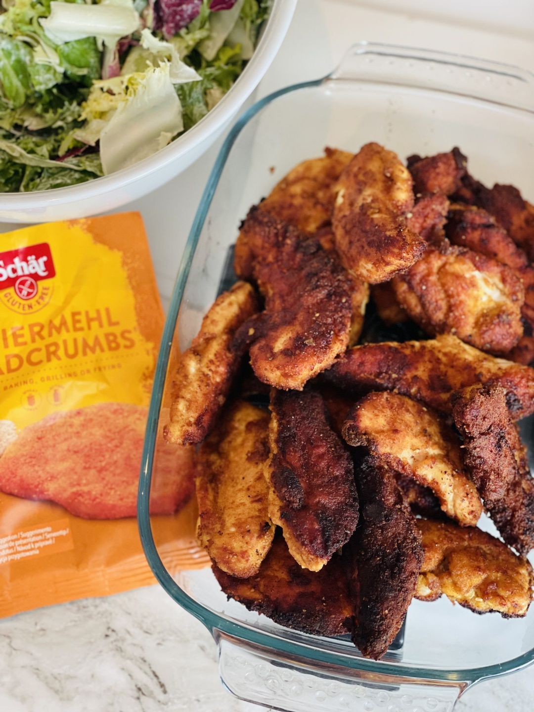 Crispy chicken fingers with a fresh salad