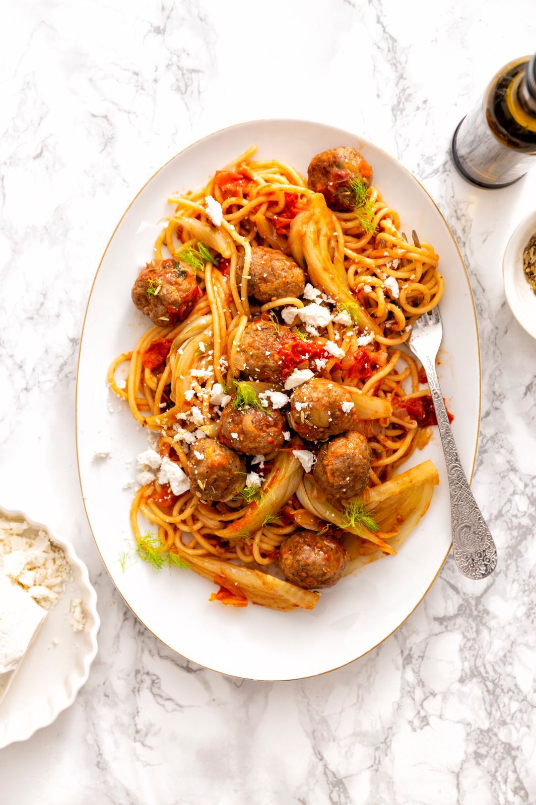 Spaghetti with meatballs and fennel in tomato sauce