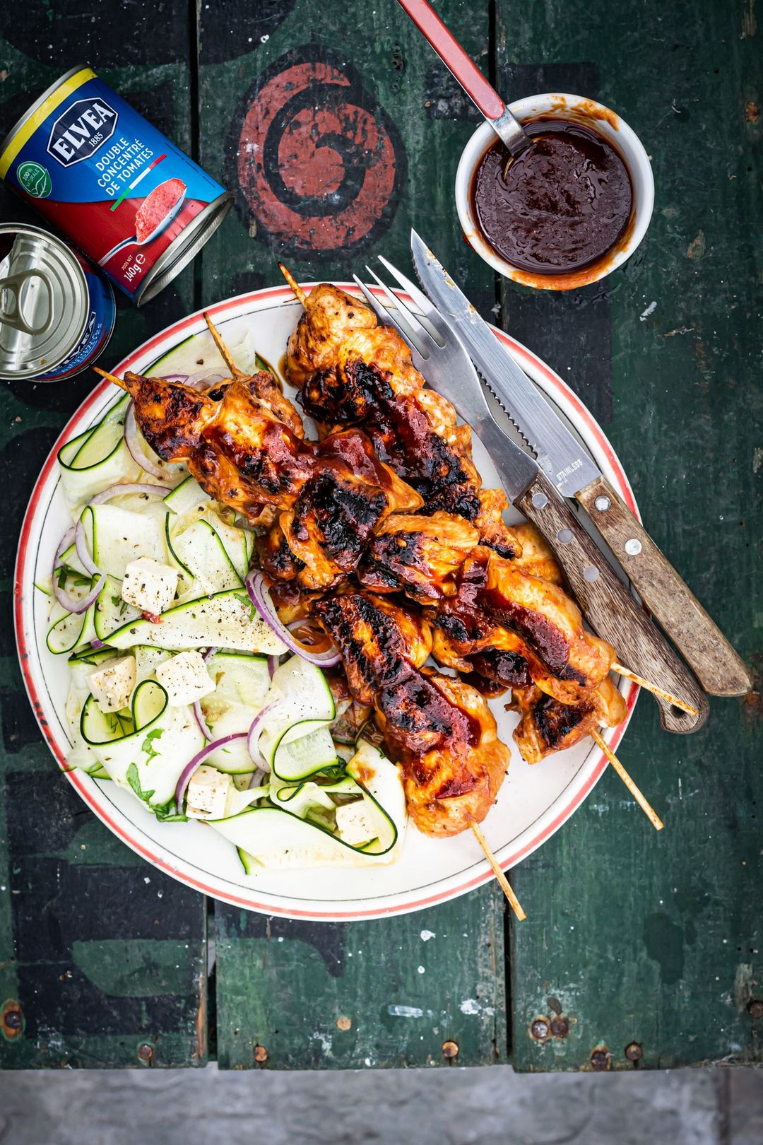 Barbecue sauce, chicken skewer and zucchini salad
