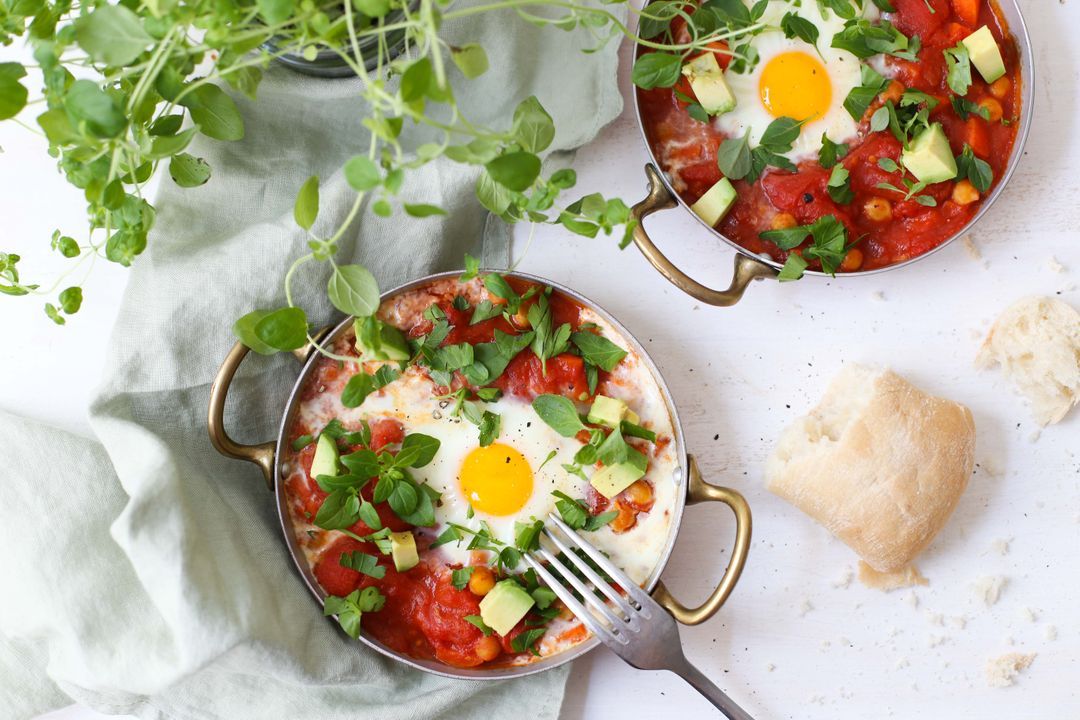 Chickpea and tomato stew with avocado and eggs