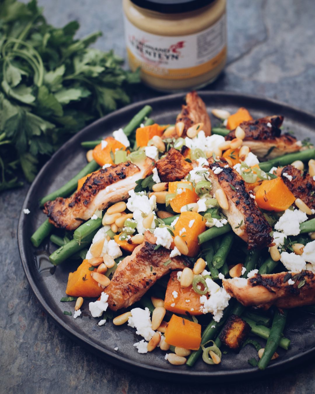 Mustard chicken with beans, roasted butternut, feta and pine nuts