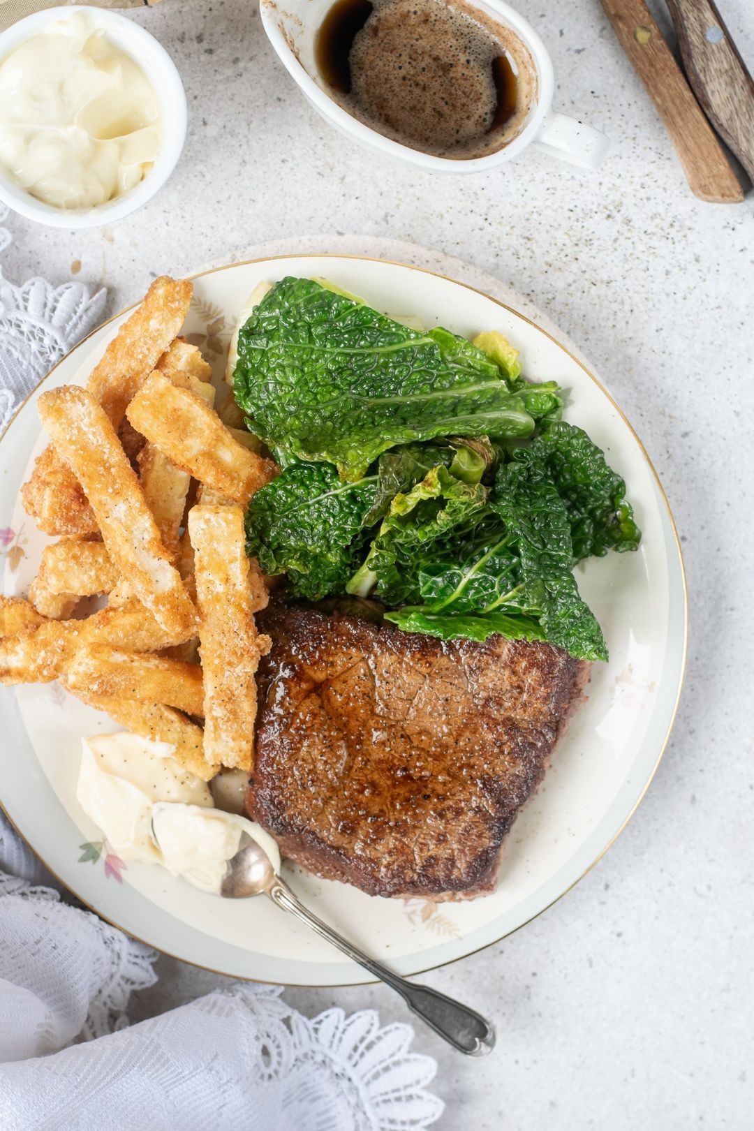 Steak with green cabbage and celeriac fries