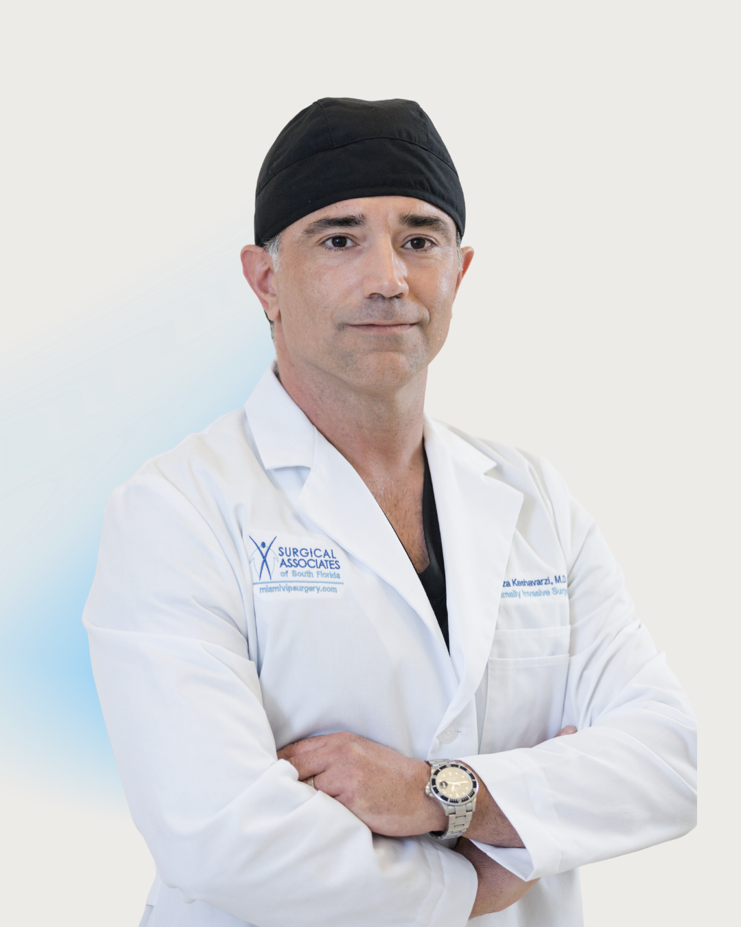 Dr. Reza Keshavarzi, bariatric surgeon, in a white coat and surgical cap