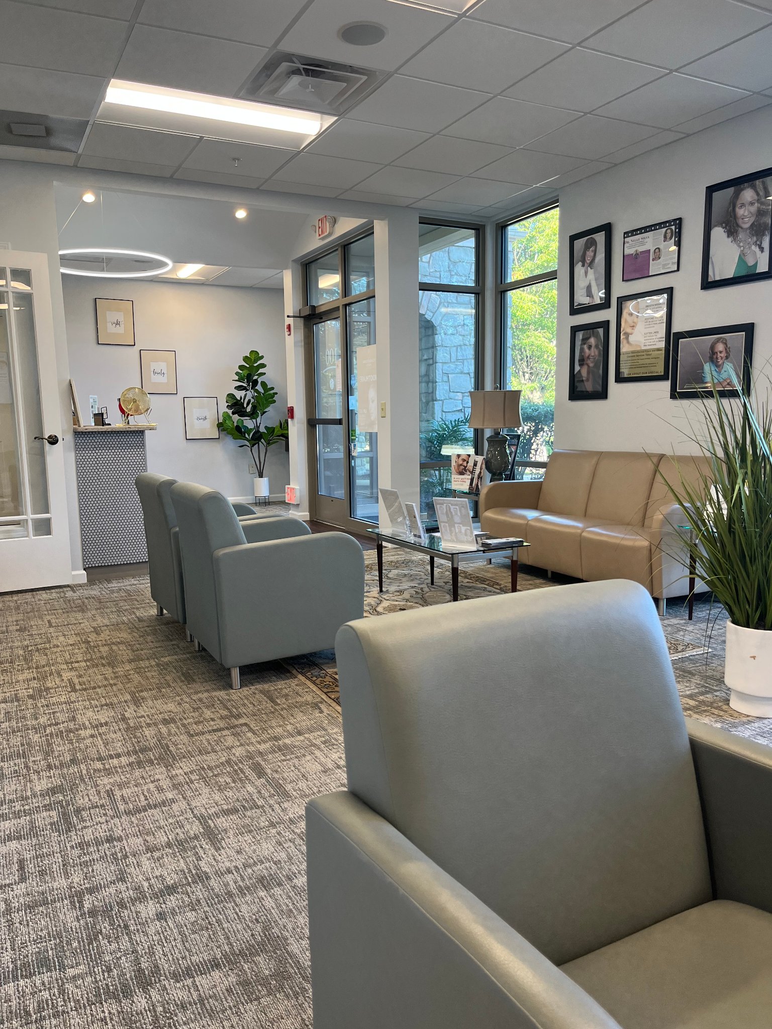 Our Collegeville waiting room with armchairs, a sofa and plants where families wait before a pediatric visit