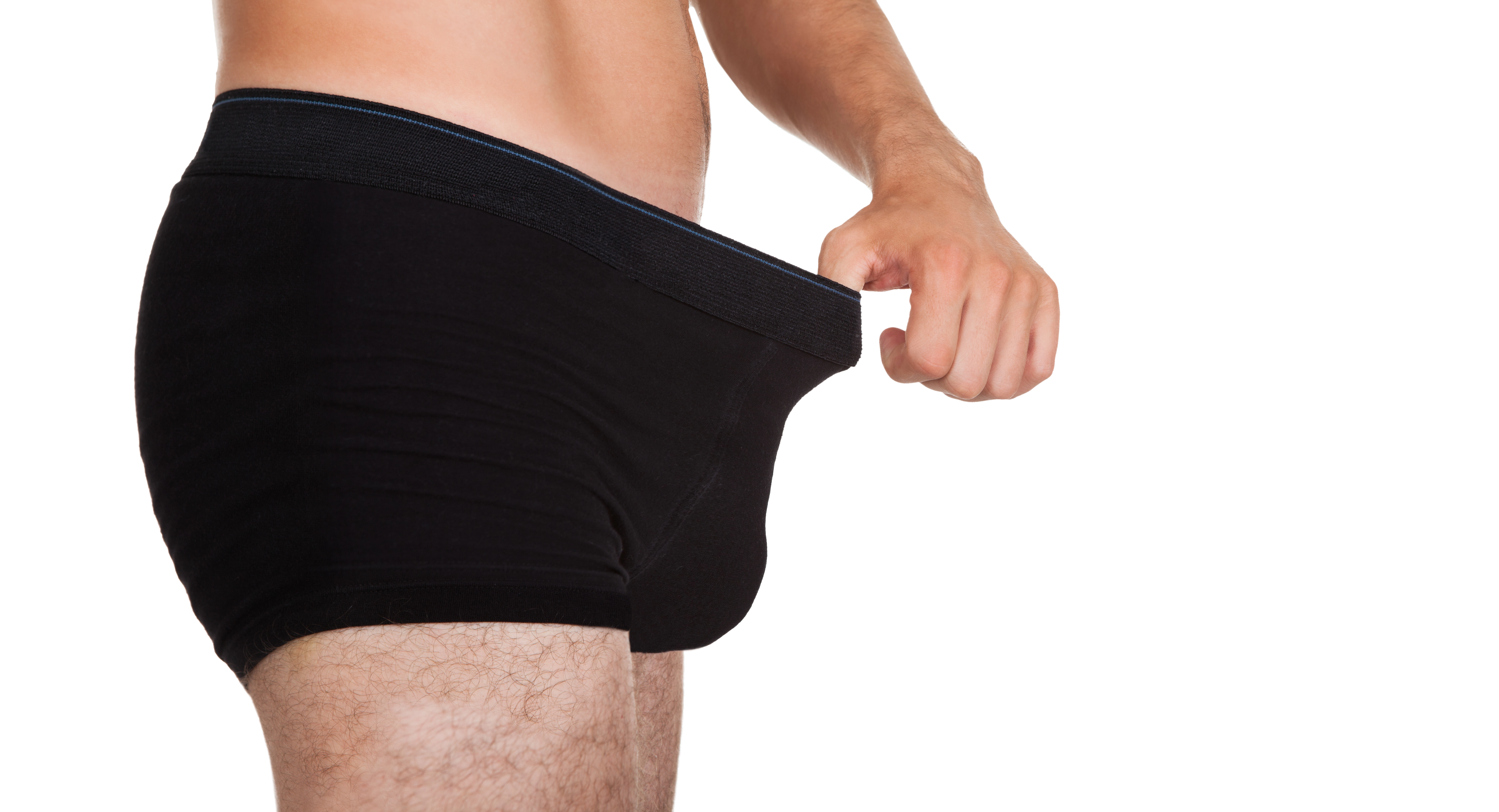 A man in black briefs pulls at his waistband, illustrating a blog post about recognizing signs of Peyronie's disease