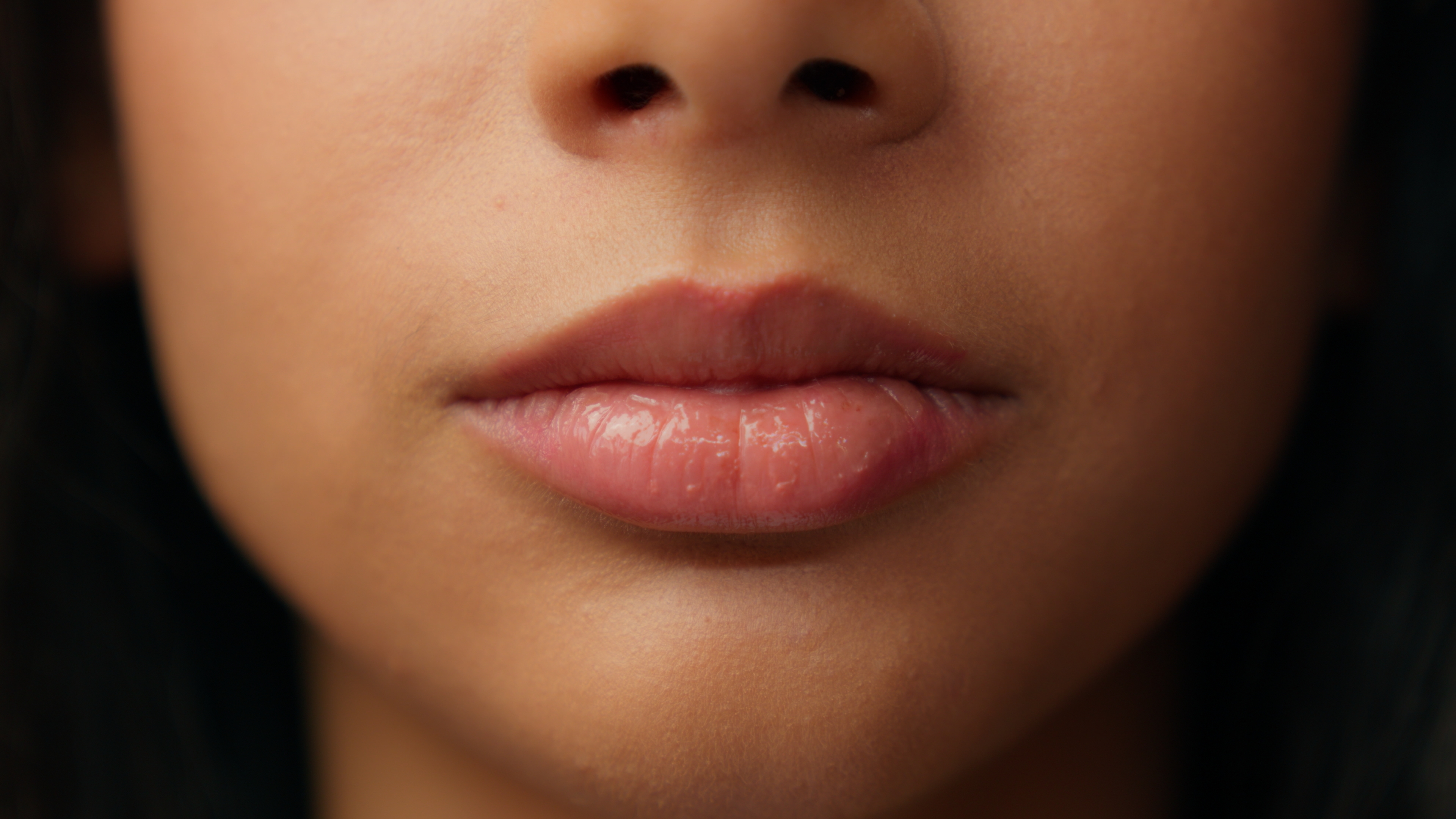 Close-up of a woman's natural, smooth lips and lower face