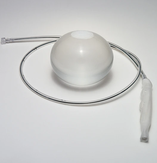 ORBERA gastric balloon filled with saline beside its thin placement catheter