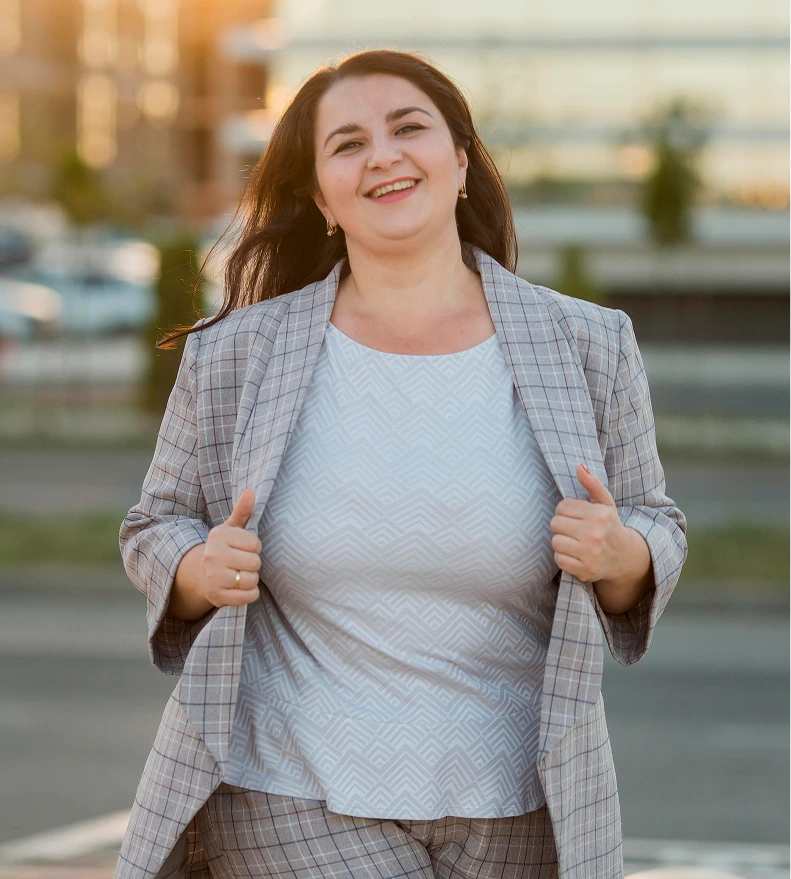 Confident woman in a blazer outdoors after weight loss surgery