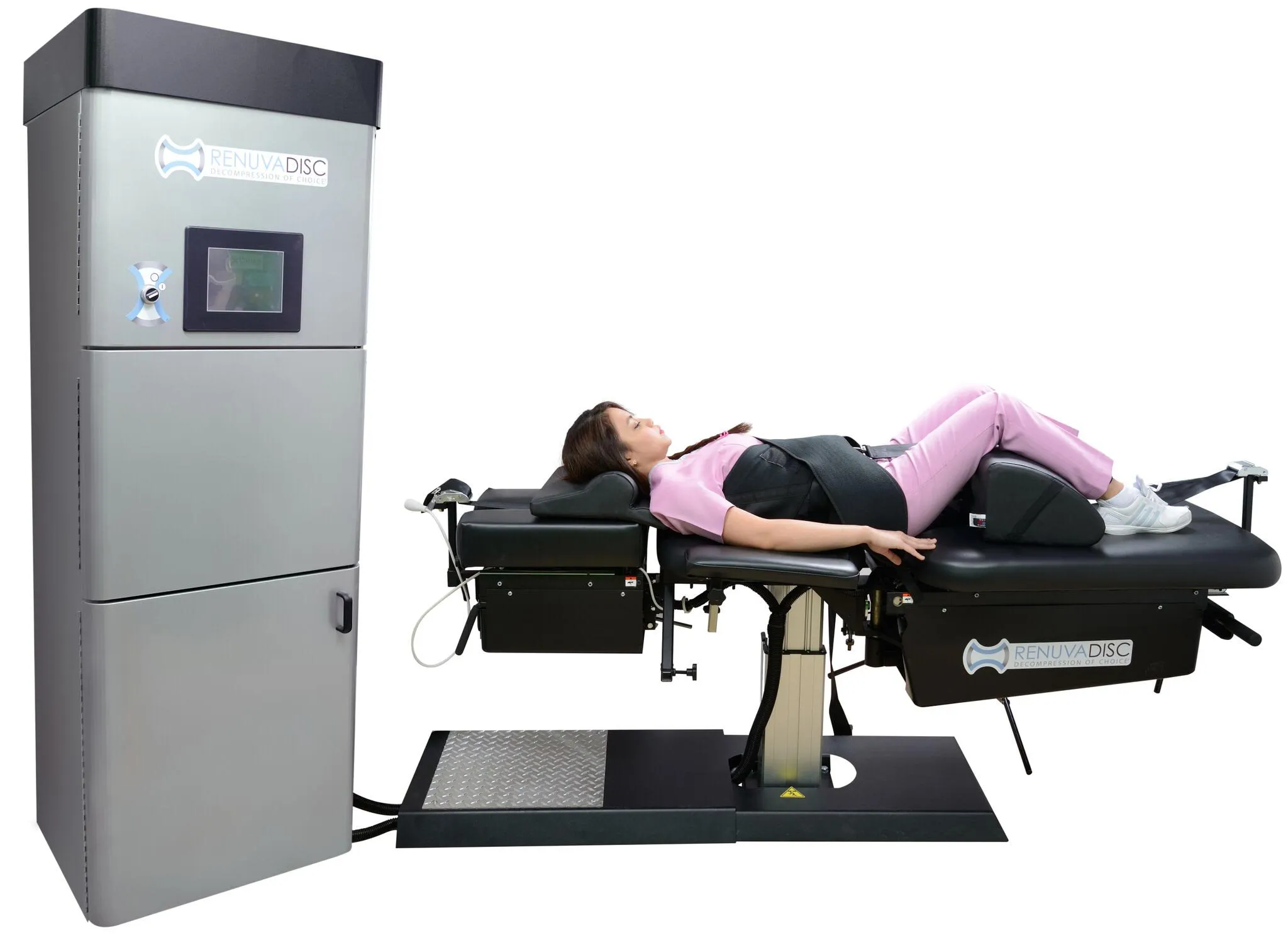 A patient lying supine on a RenuvaDisc spinal decompression table with the accompanying control unit, illustrating non-surgic