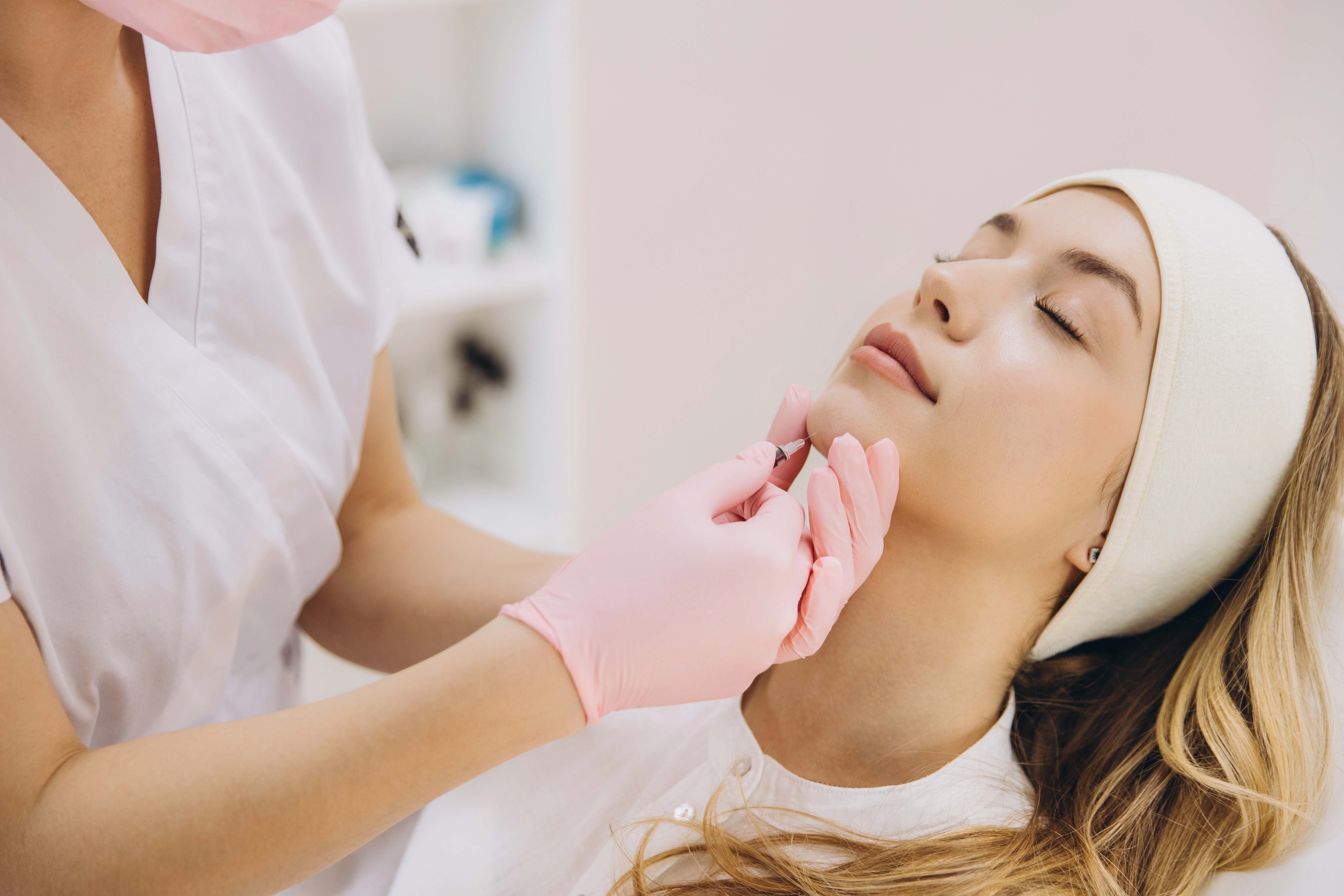 A patient relaxes during an AquaGold session in a treatment room at Treat Medspa.