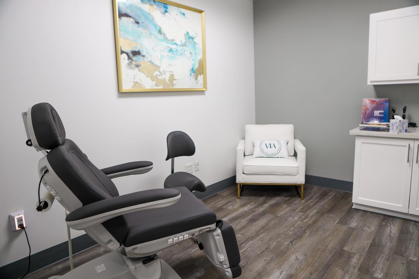 Procedure room with a reclining treatment chair and a VIA pillow, where eyelid lift patients are seen